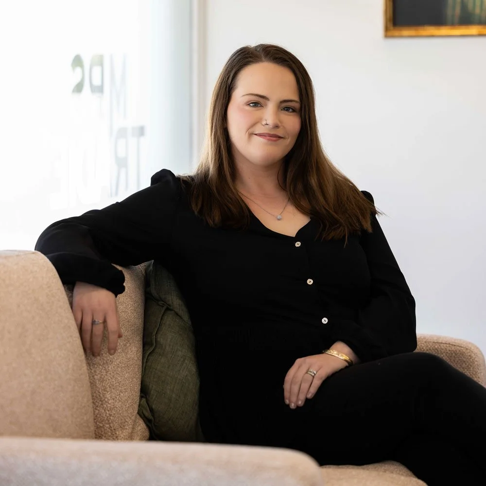 kim sitting on couch smiling