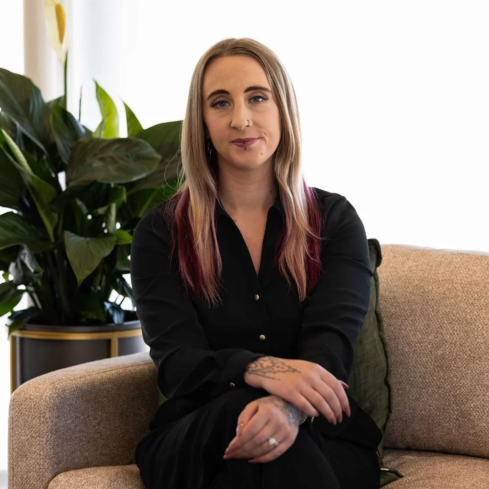 krystal sitting on couch smiling