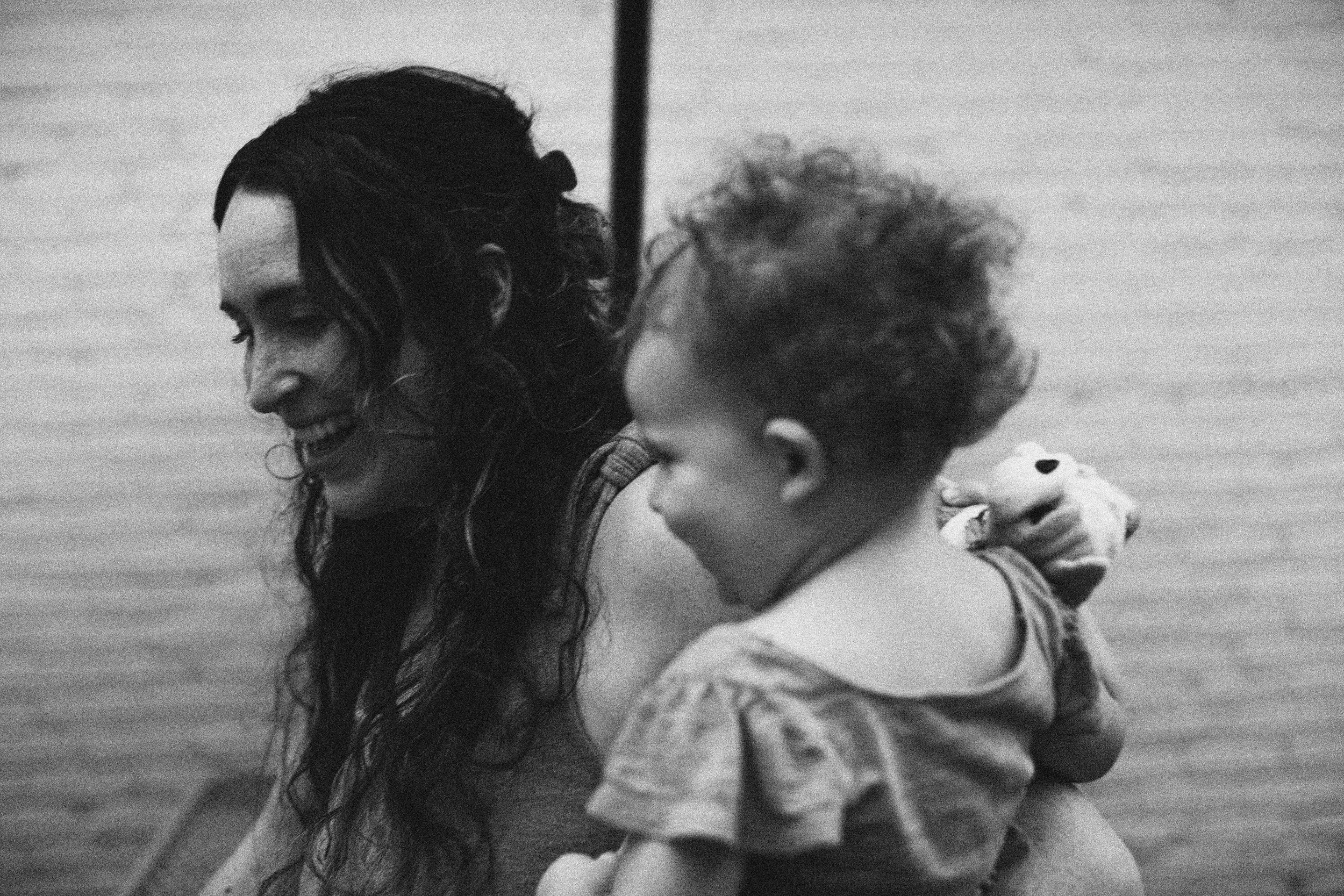 Black and white photo of a mother holding her child close, representing connection and support in maternal mental health