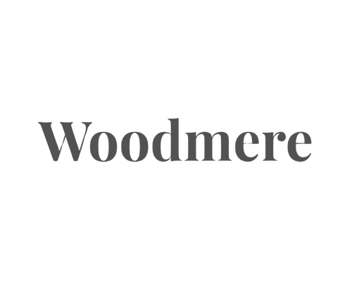 The logo of Woodmere, with a black background and the brand name in gray text.