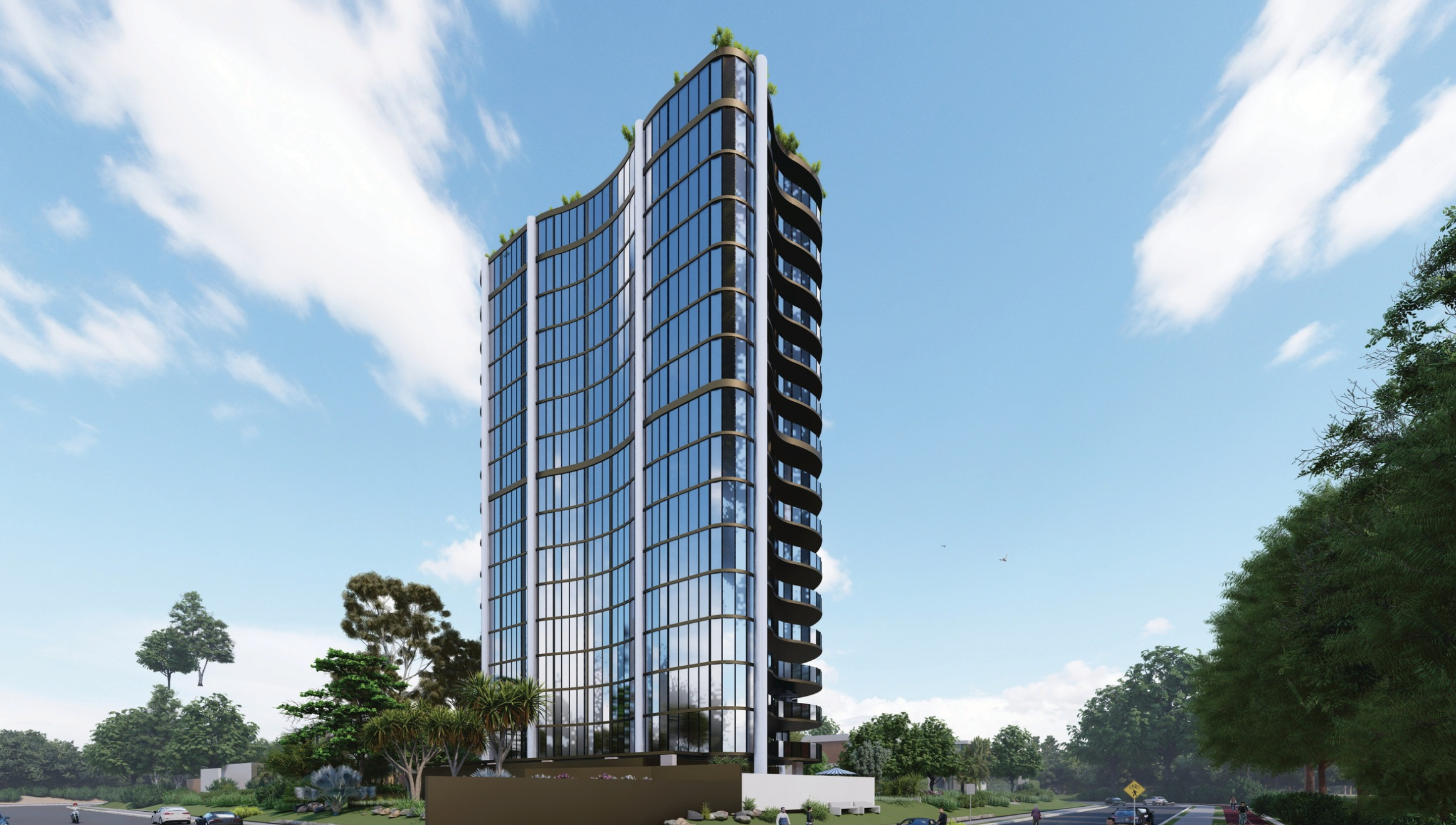 A modern high-rise glass building with curved balconies on the right side, surrounded by greenery under a partly cloudy sky.