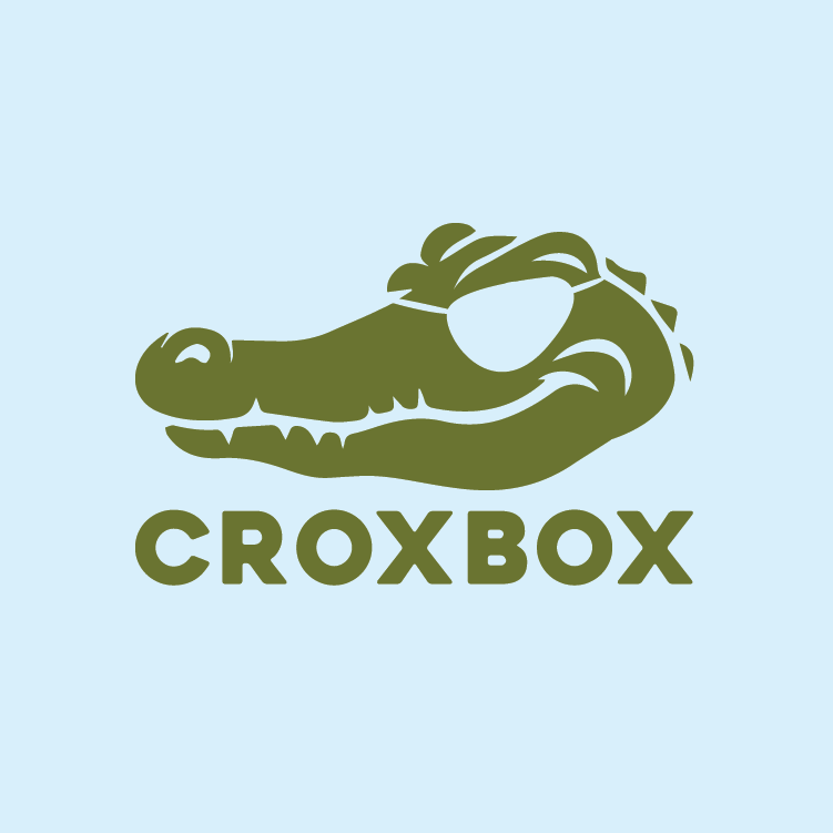 A green crocodile head with an eyepatch logo on a light blue background and the word 'CROXBOX' underneath, which is the name of an easy to install, pin lock parcelbox for easy and safe delivery.