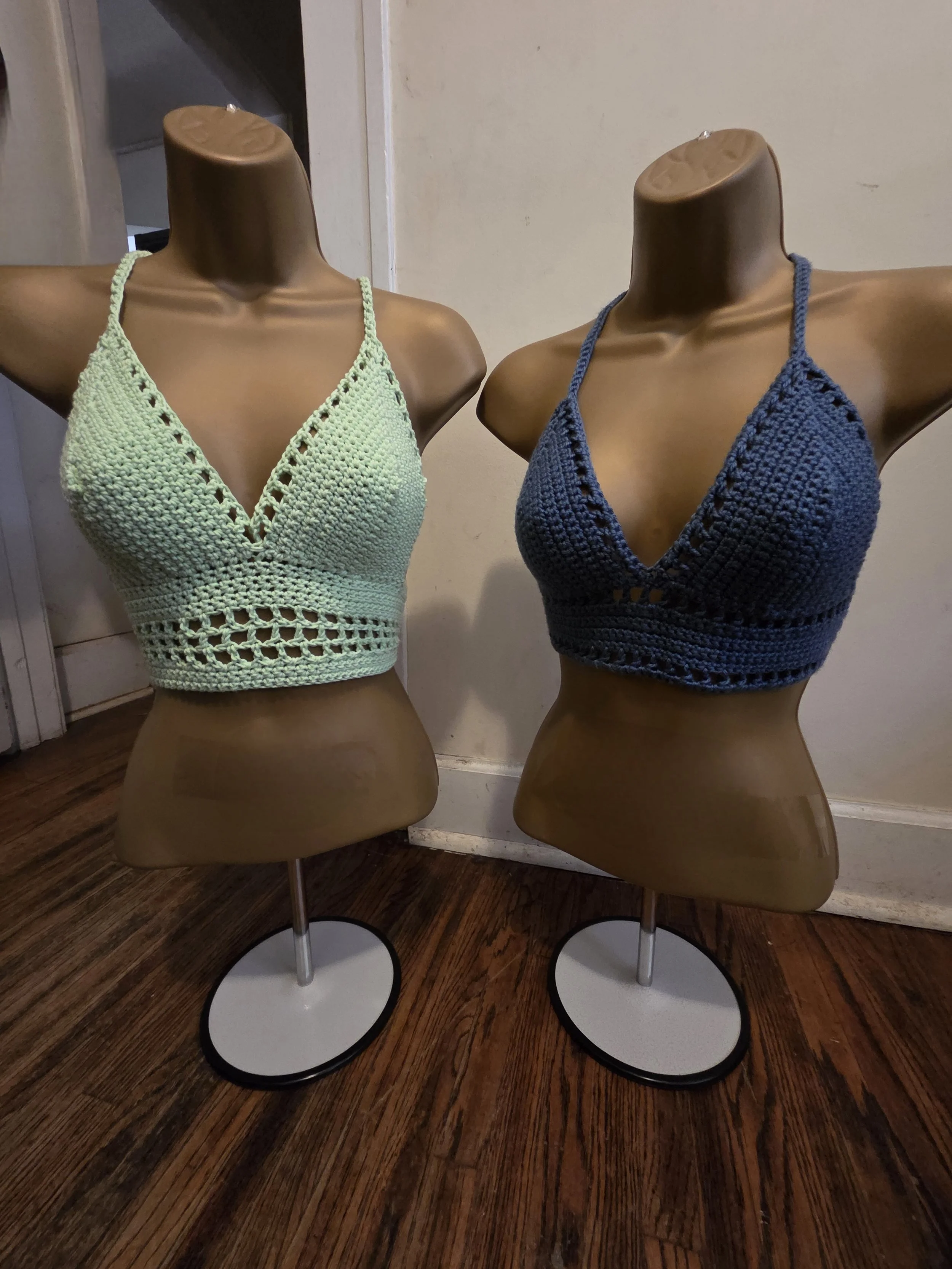 Handmade crochet bralettes in glow-in-the-dark and blue side by side