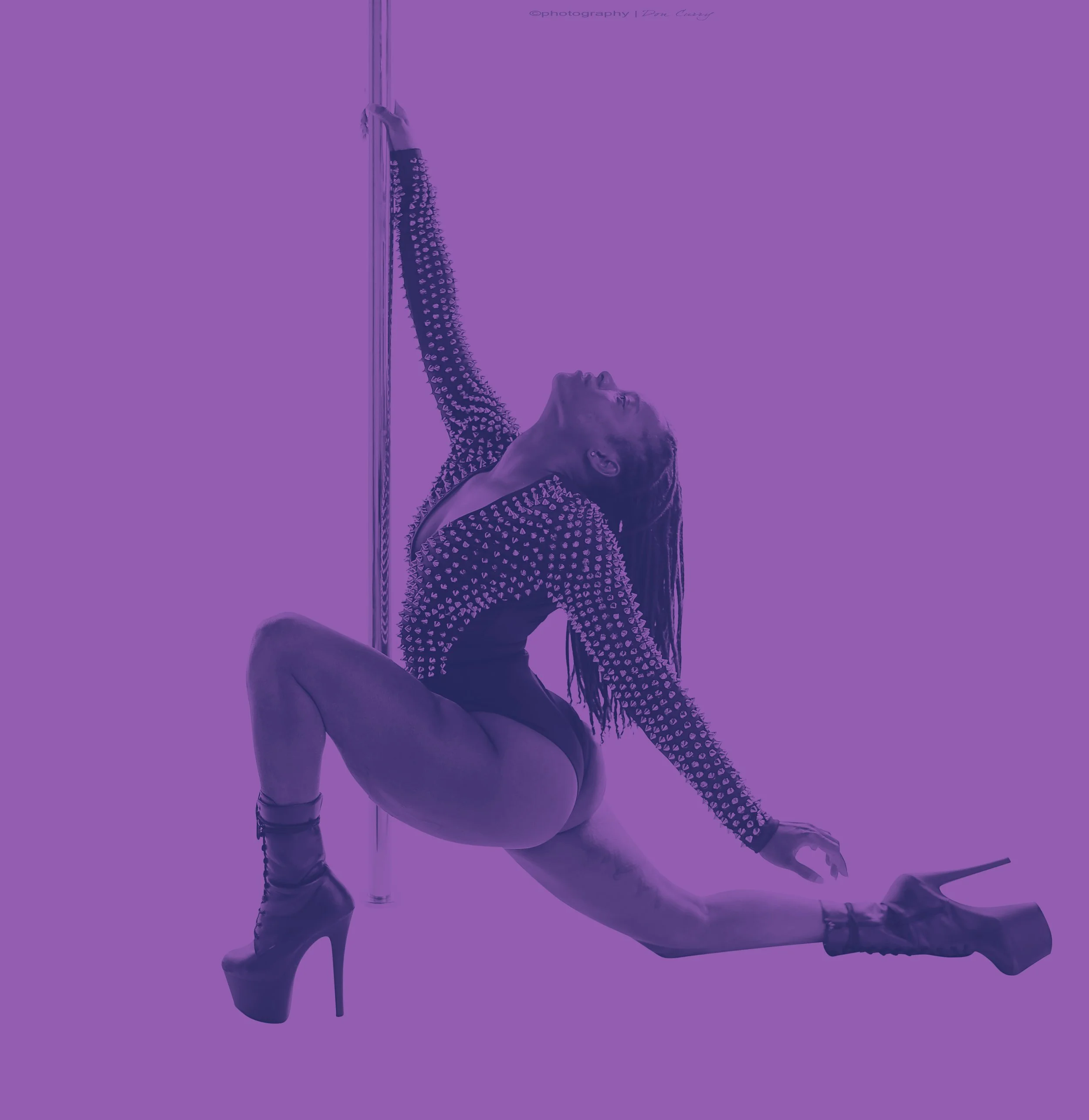Jasmyn holding an extended lunge position from the floor. looking up toward the ceiling.