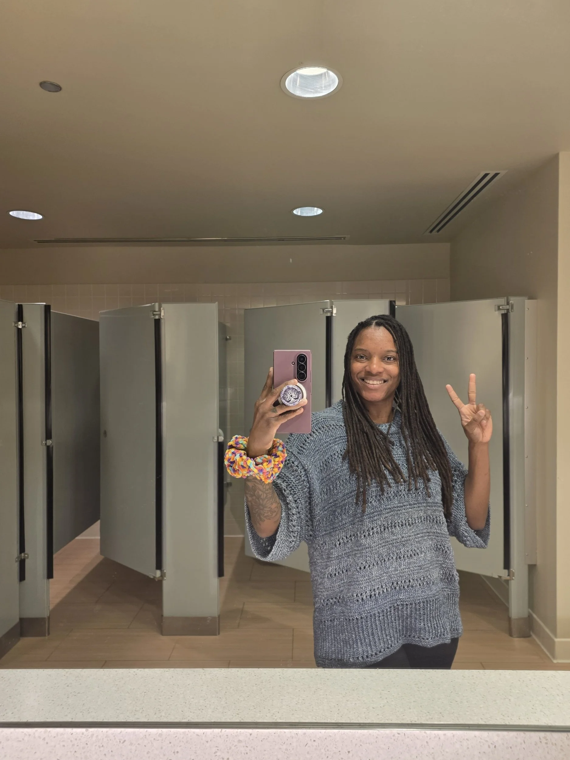 one women in mirror bathroom photo wearing a handmade crochet lacey tee