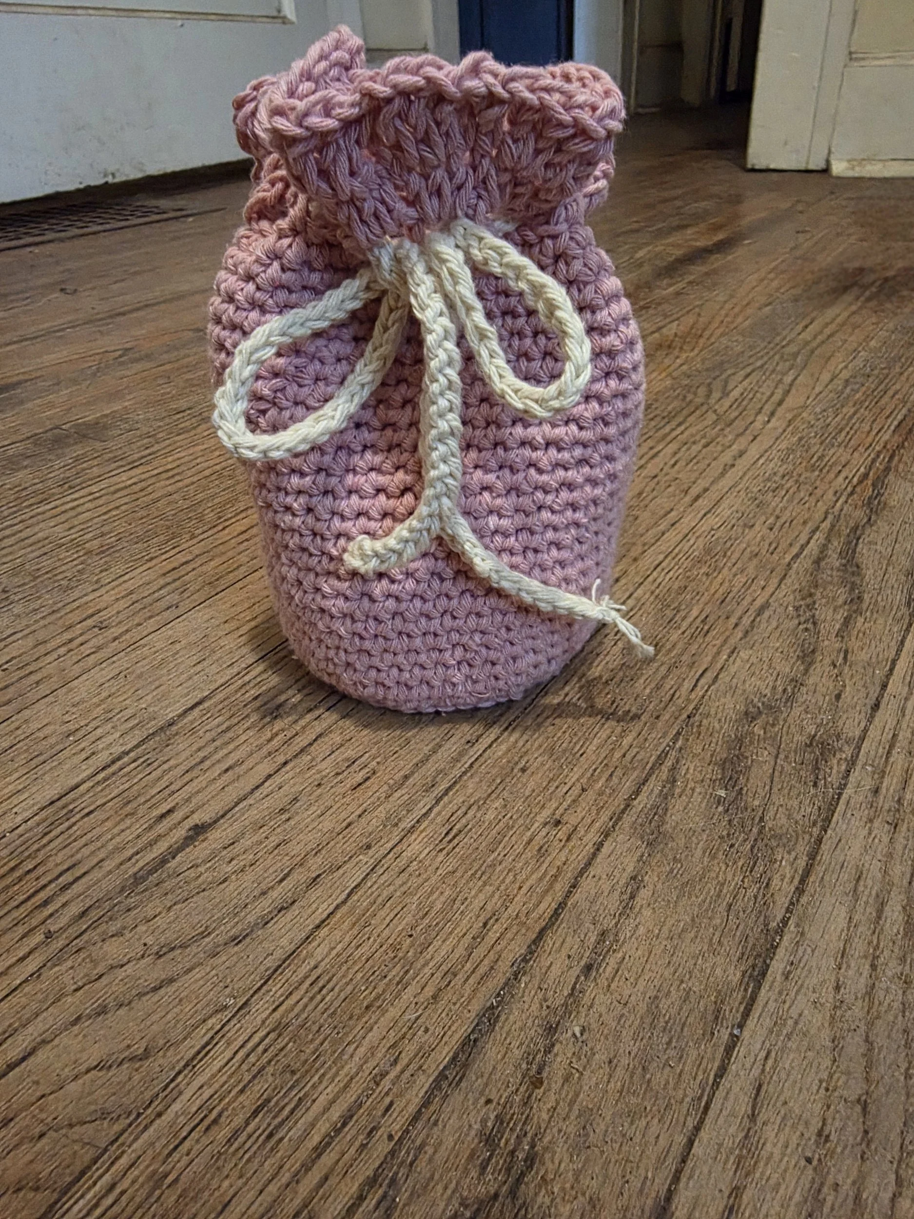 Handmade crochet drawstring bag in pink by Jasmyn Steele
