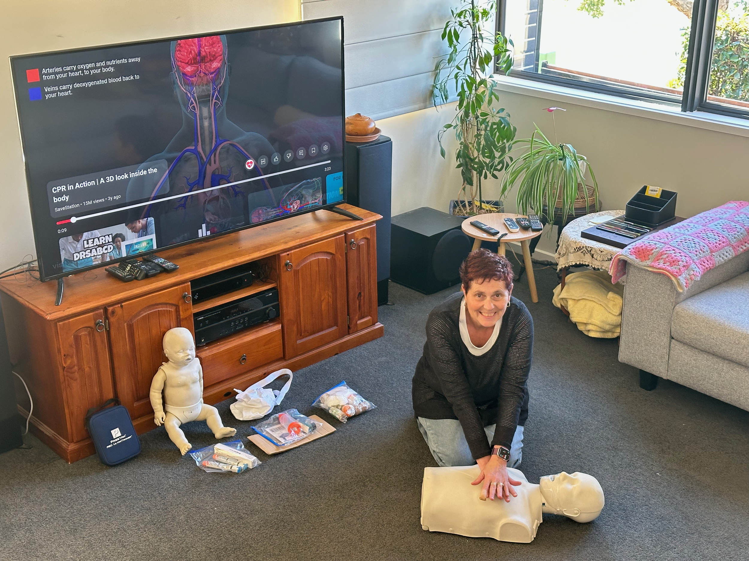 Lorrie Jones performing CPR on a class mannikin at gungahlia first aid home premises