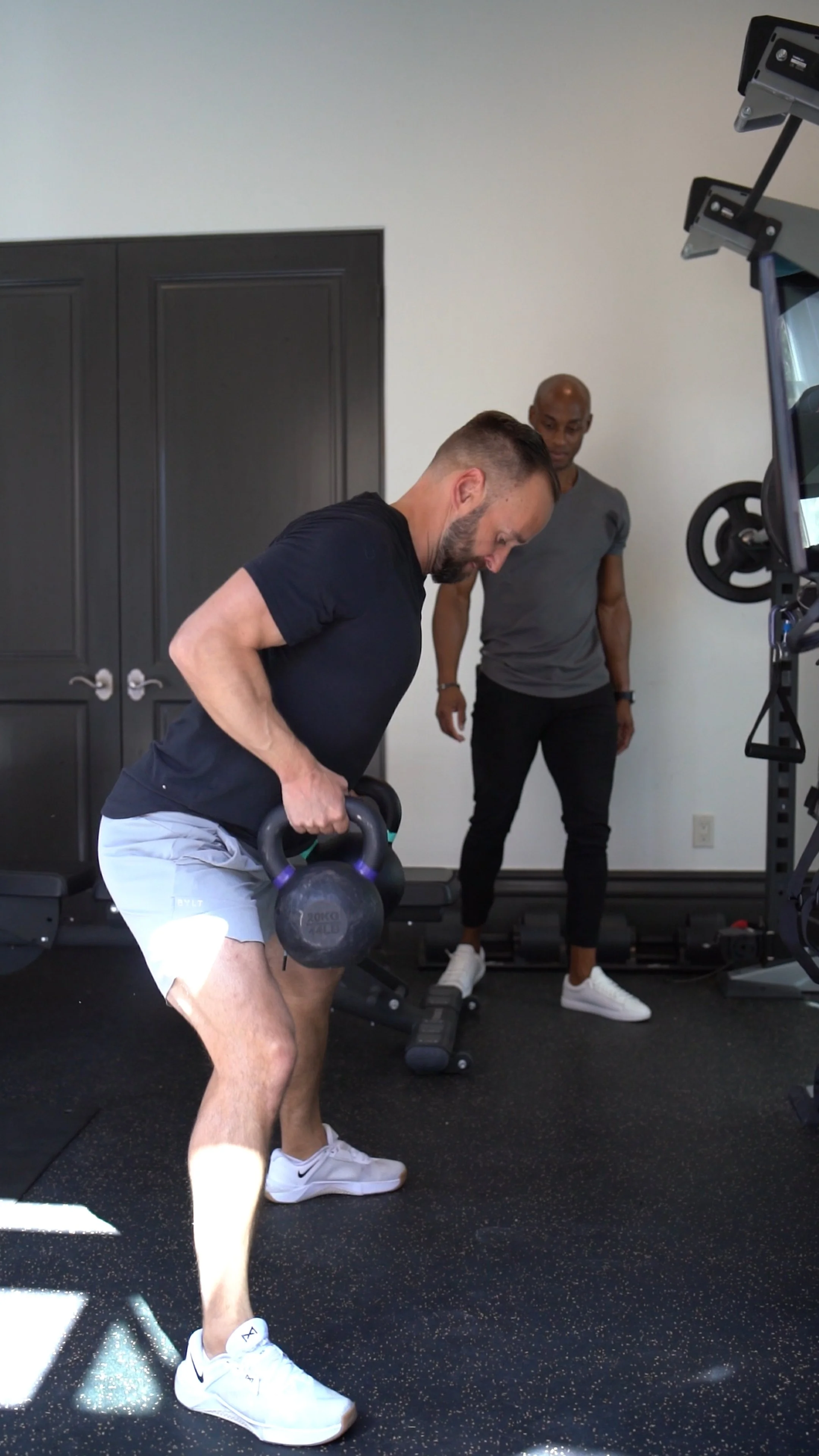 Executive client doing kettlebell training with coach Akram Hameed in Scottsdale