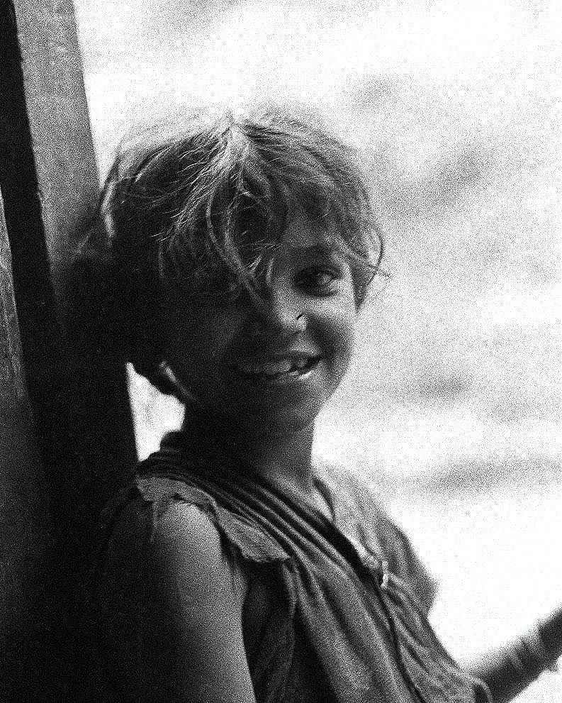 A curious child, keen to engage
  foreign passers-by