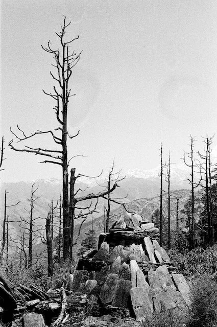 mani stone in deforested hillls