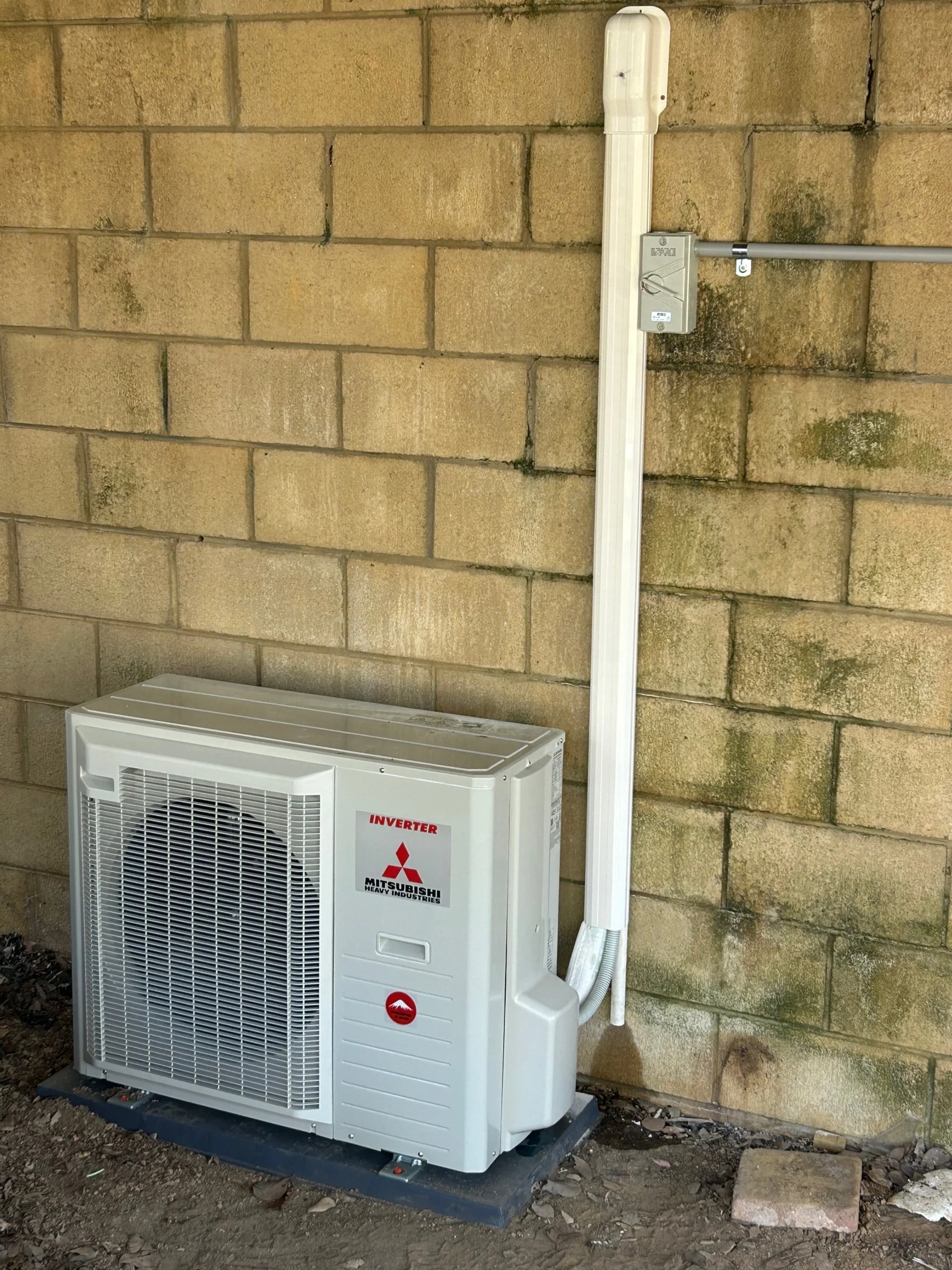 Electrical unit plugged into a wall outdoors