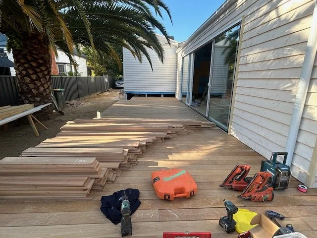 Decking materials and tools on top of a work in progress deck.