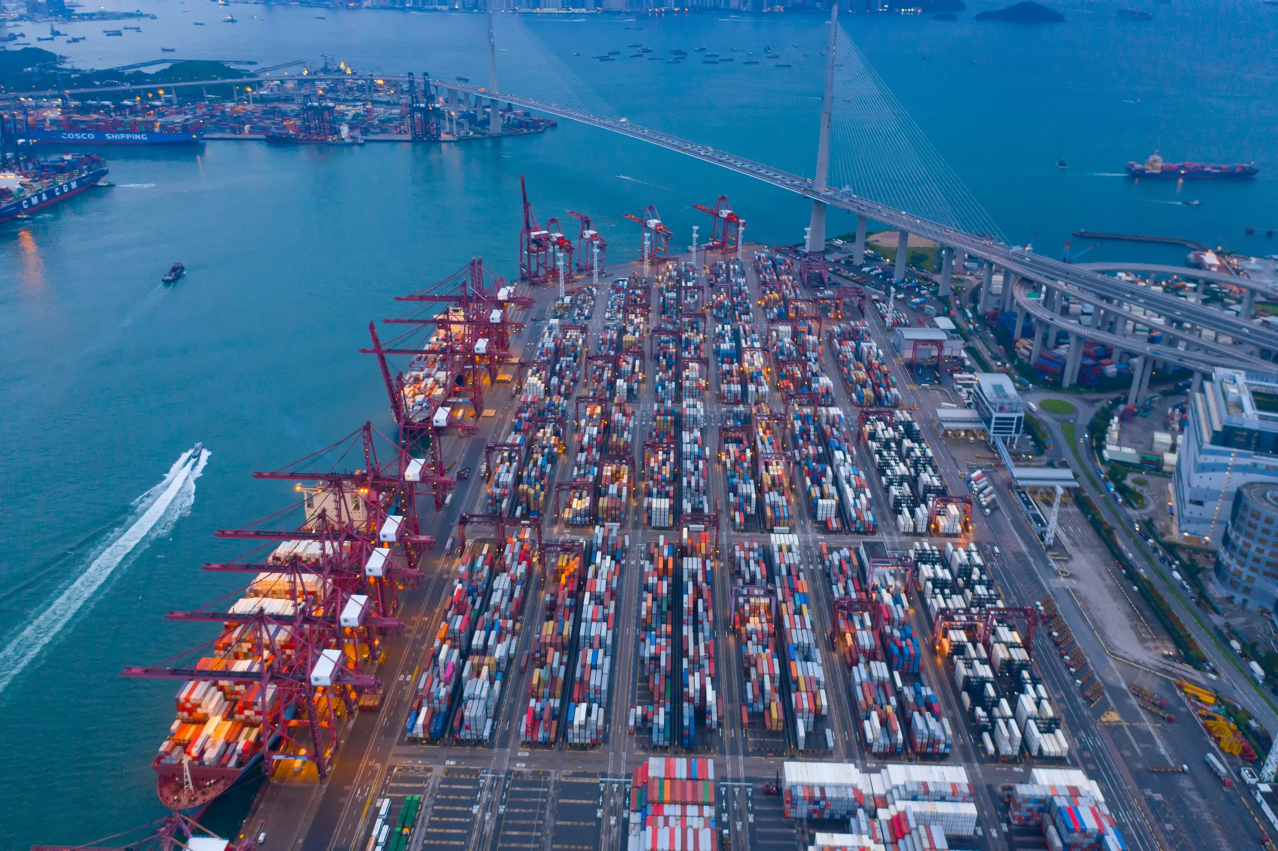 Aerial view of a yard showing all the containers being imported and exported on the ship in port.