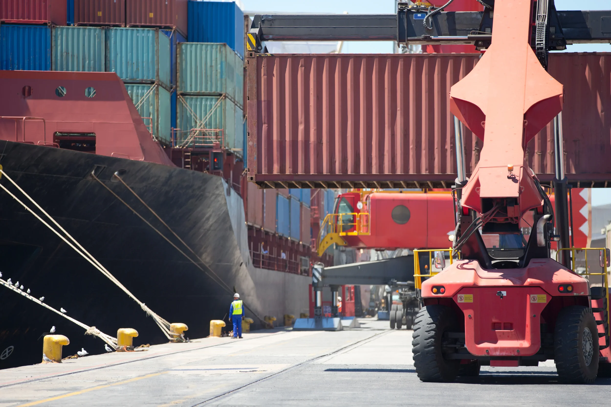 Overview of a port showing the unloading of exported products.