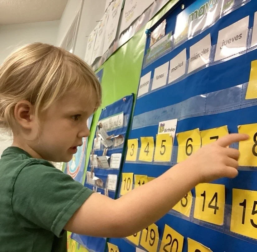 Our children build confidence, practice communication skills, learn to listen, follow routines, and grow together as a classroom community.

Today, Oakley was fully concentrated while counting the numbers on the calendar in Spanish! 🇪🇸🔢 These mean