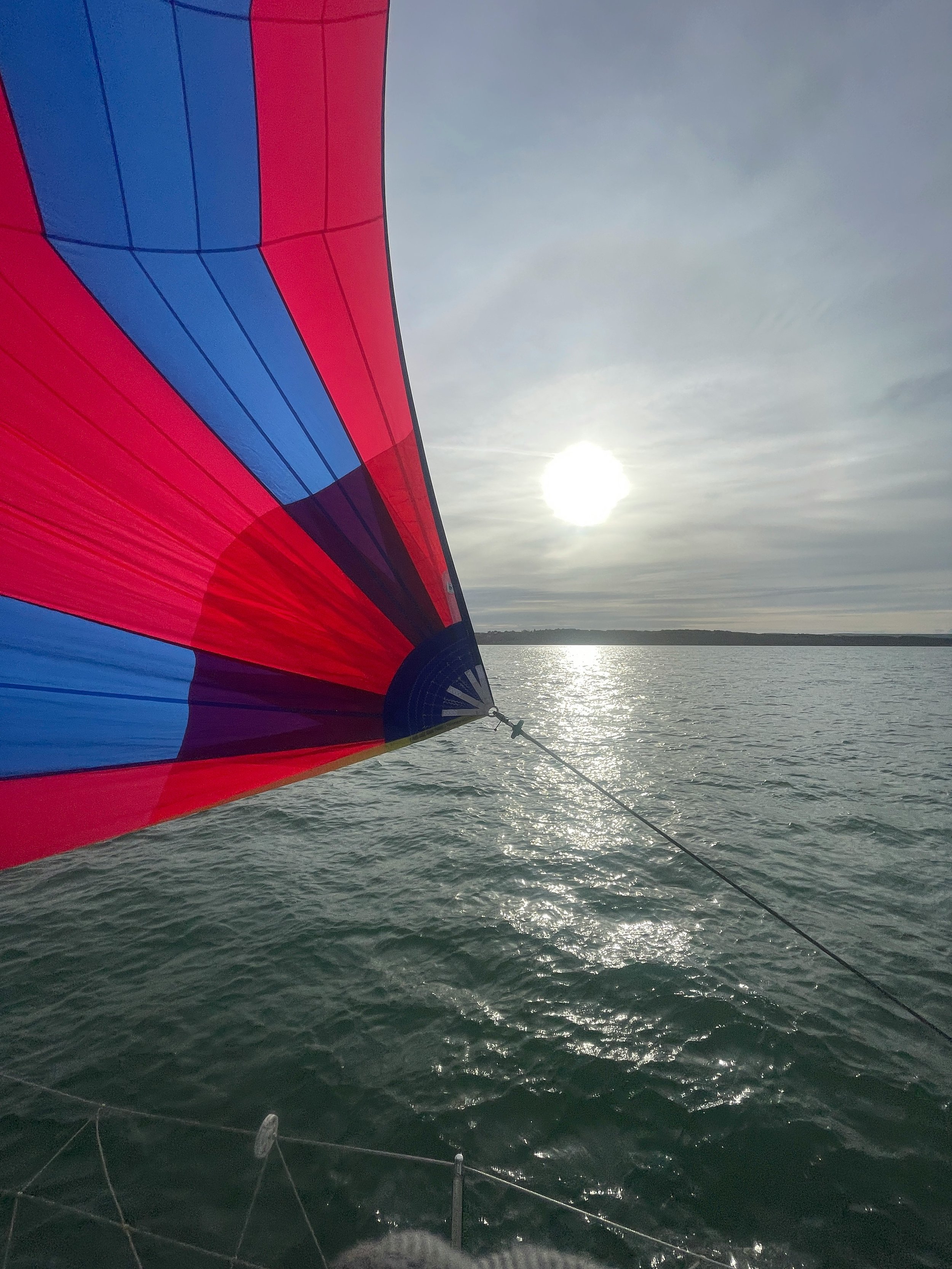 Racing sailboat with the spinnaker filled ahead of the competition
