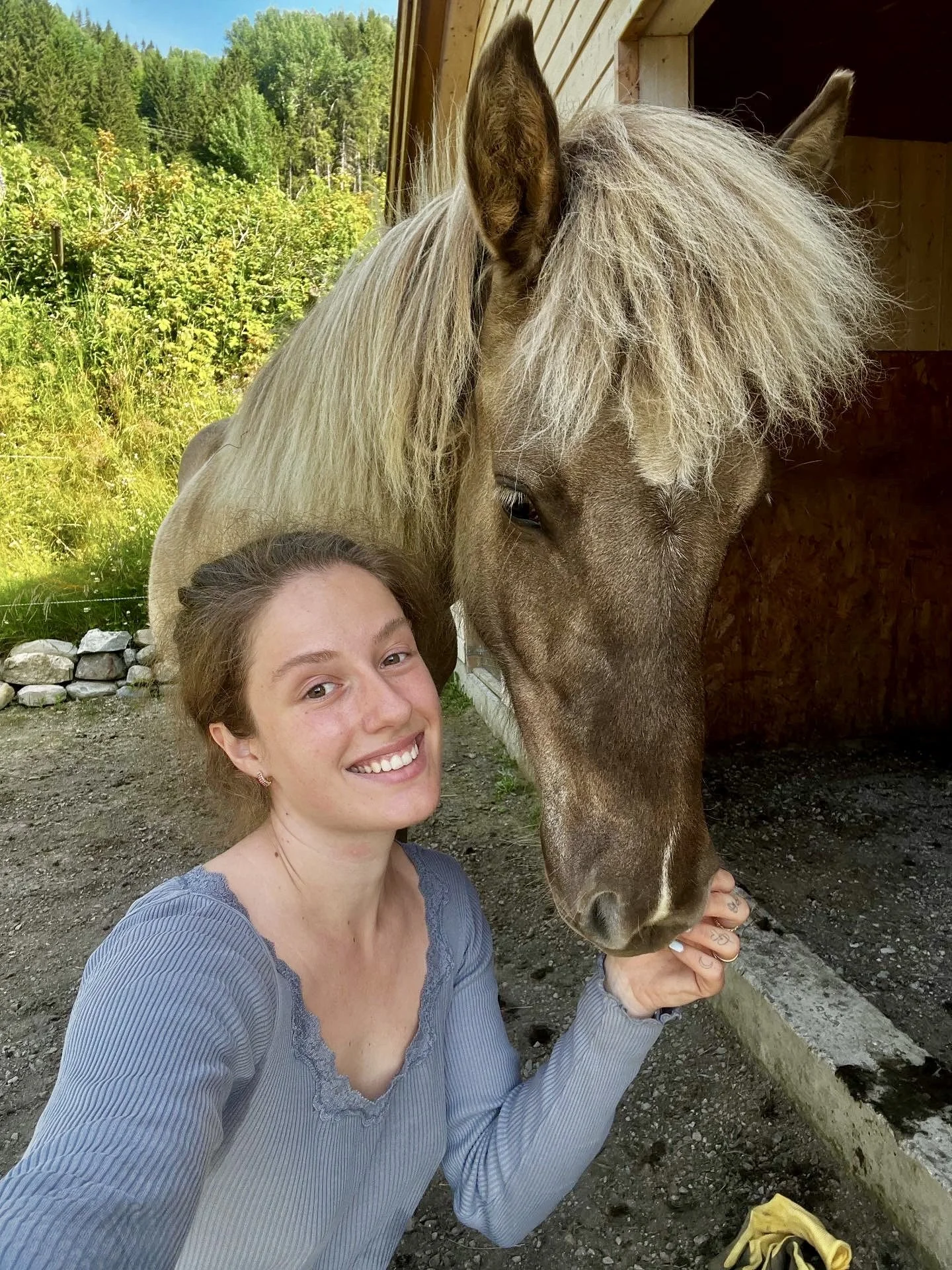 Friendly selfie of the artist with her Icelandic horse, introducing the creator behind handmade custom crochet animal plushies and showcasing a personal connection to horses and craftsmanship.