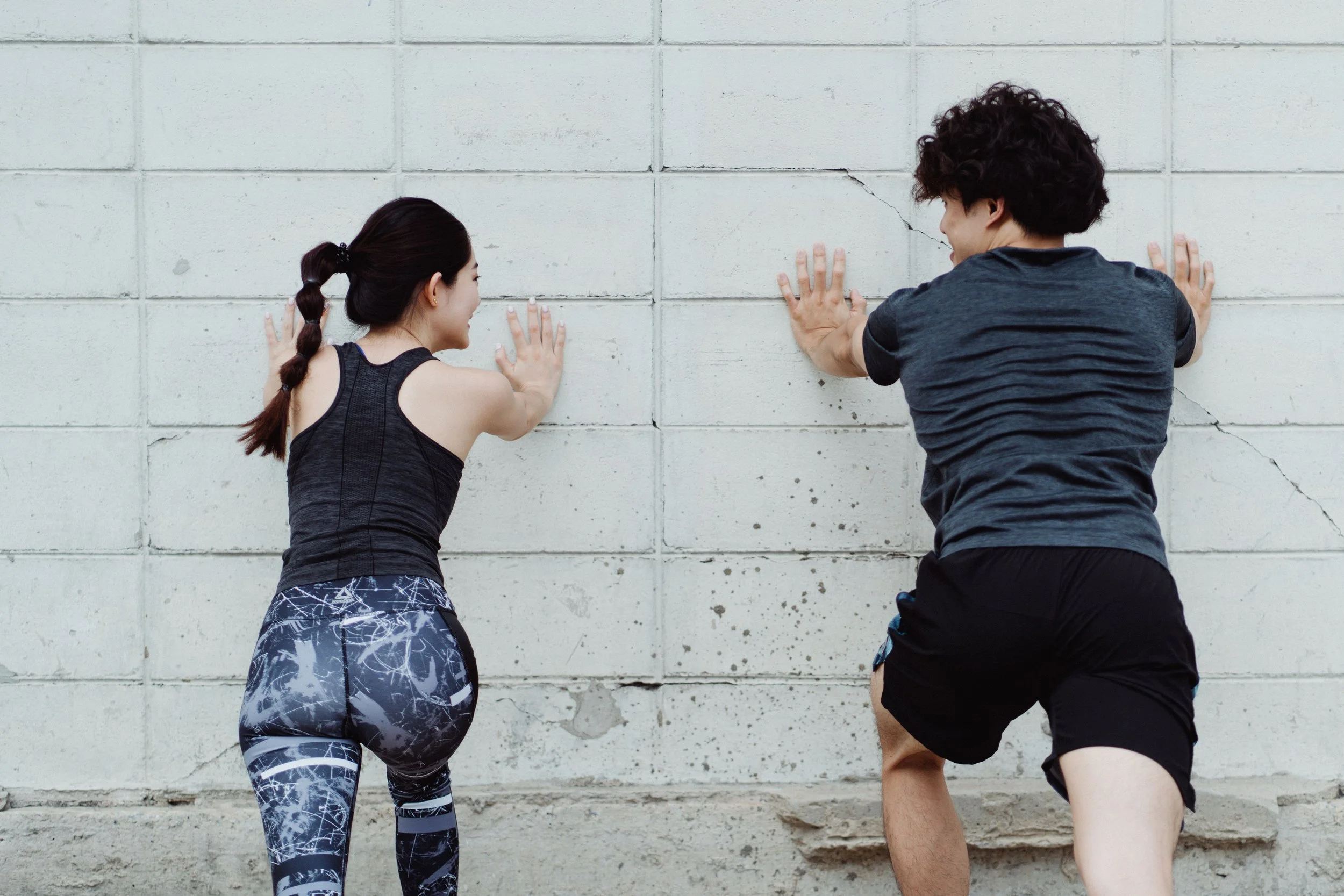 two people pushing the wall