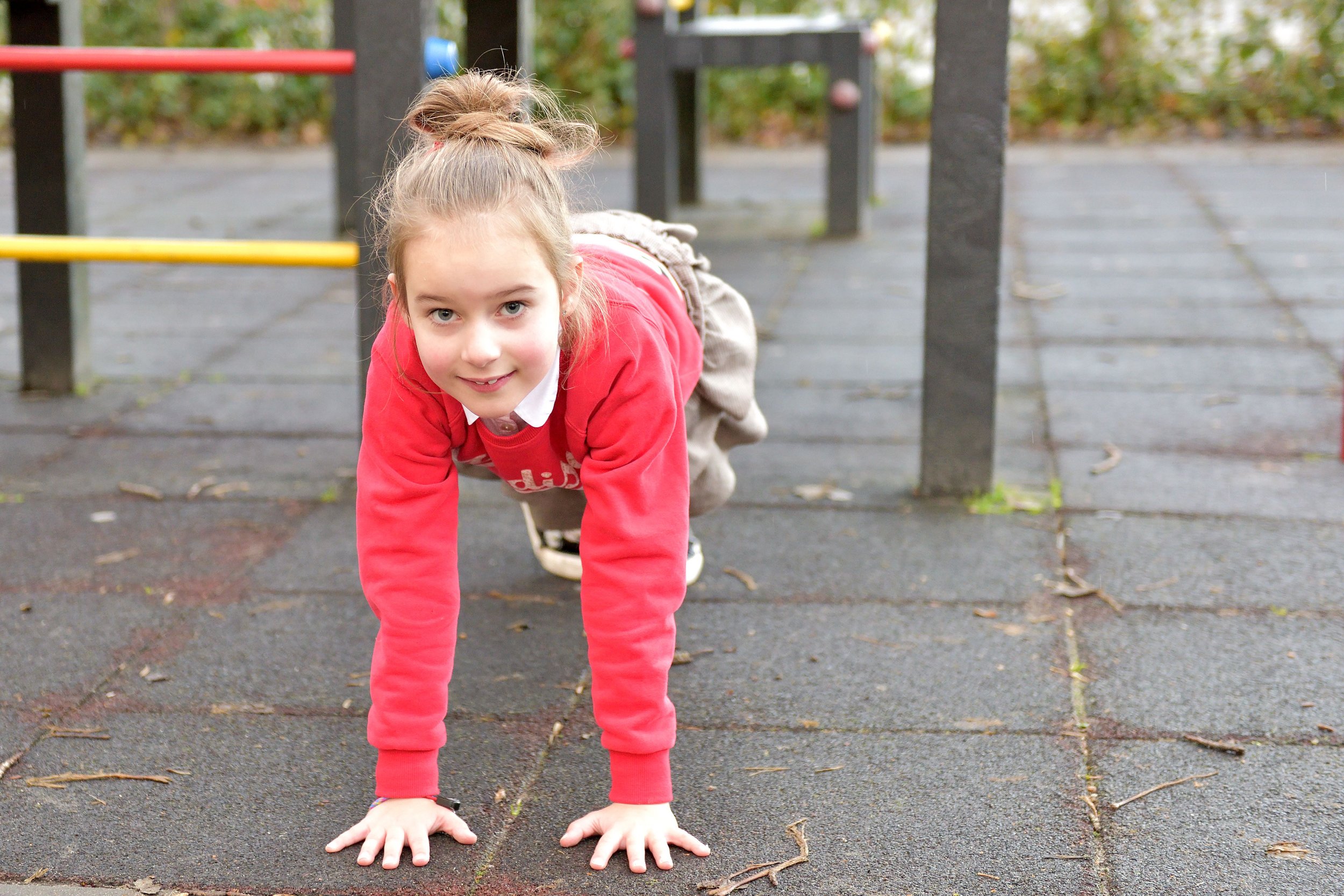 girl on all fours in a plank position