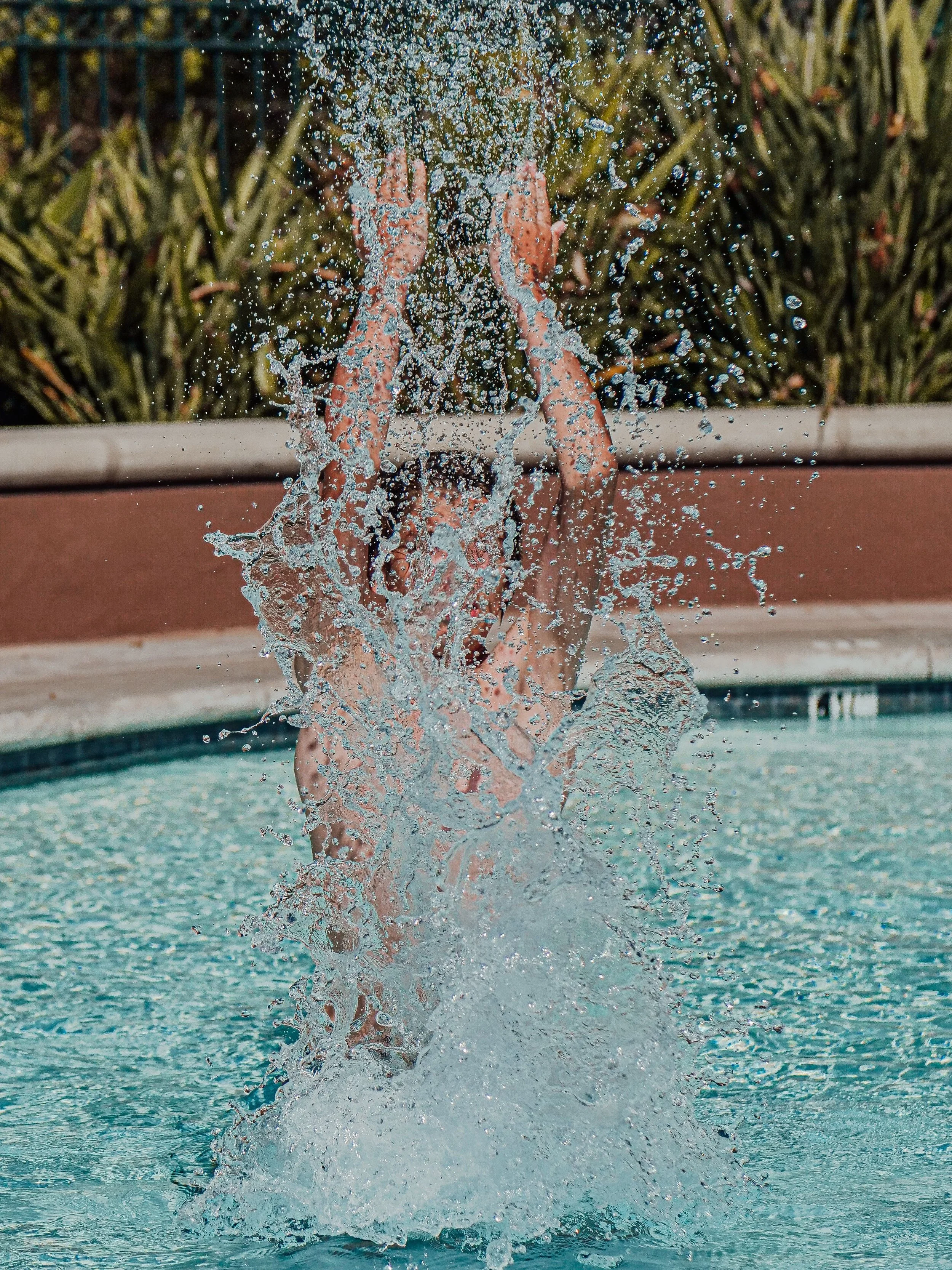 splashing out of the water in a pool