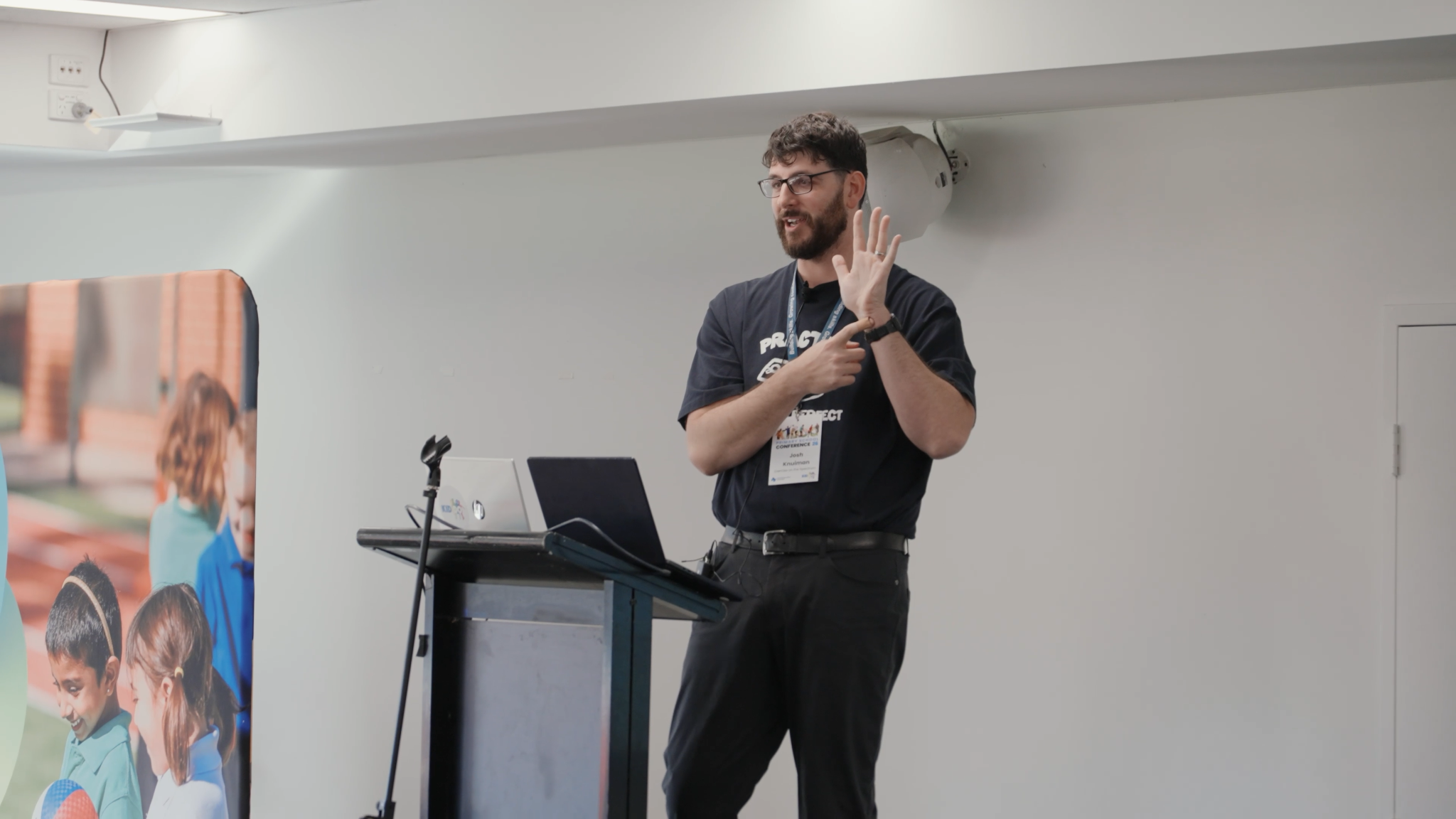 autism consultant Josh Knuiman on stage at a conference discussing the hand model of the brain