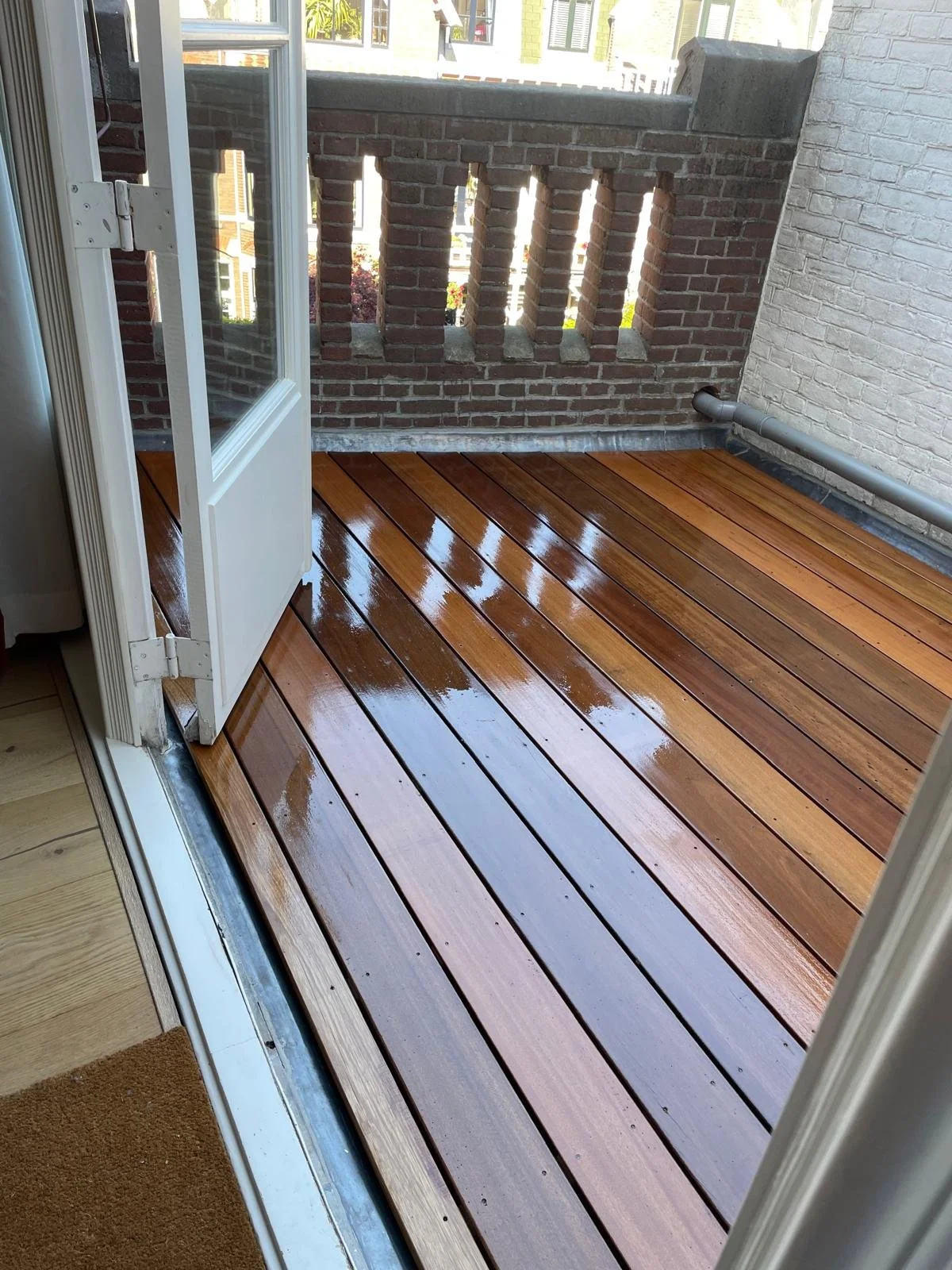 Wooden deck for an old building. Waterproofed covering beneath, covered by hardwood with an oil finish to be weather resistant.