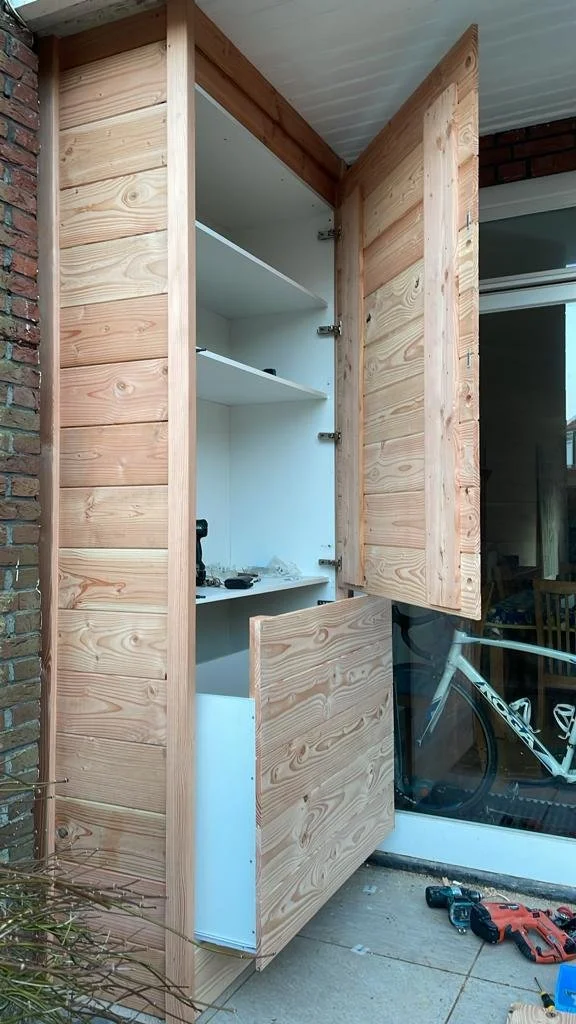 Outdoor dry storage, waterproof. Custom built with drawers and cupboard doors, timber finish.