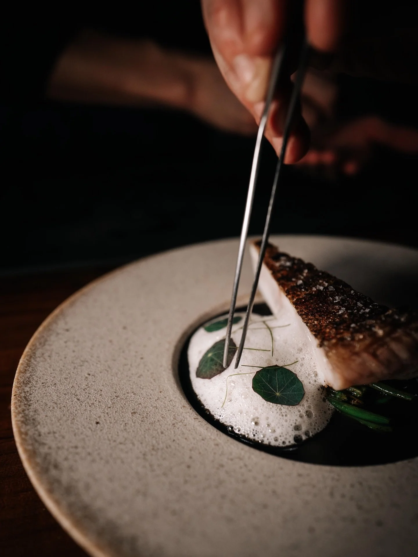 Tatler Asia spotlights Chef Law Jia Jun once again as a bold chef redefining Singaporean cuisine through curiosity and respect. With experience from acclaimed restaurants like Atelier Crenn, he views ingredients as stories to be told, such as midin, 