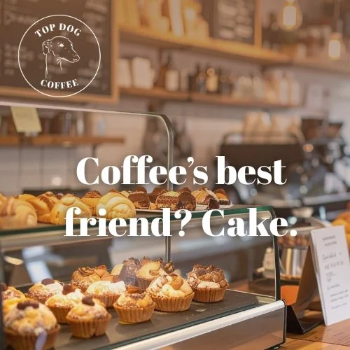 Display case with assorted baked goods at a coffee shop, with a sign referencing cake as coffee's best friend.