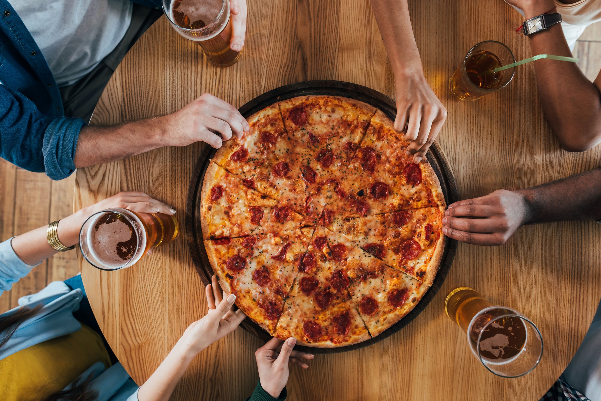 top-view-group-of-young-friends-having-pizza-in-ca-2026-01-06-00-43-03-utc.jpg