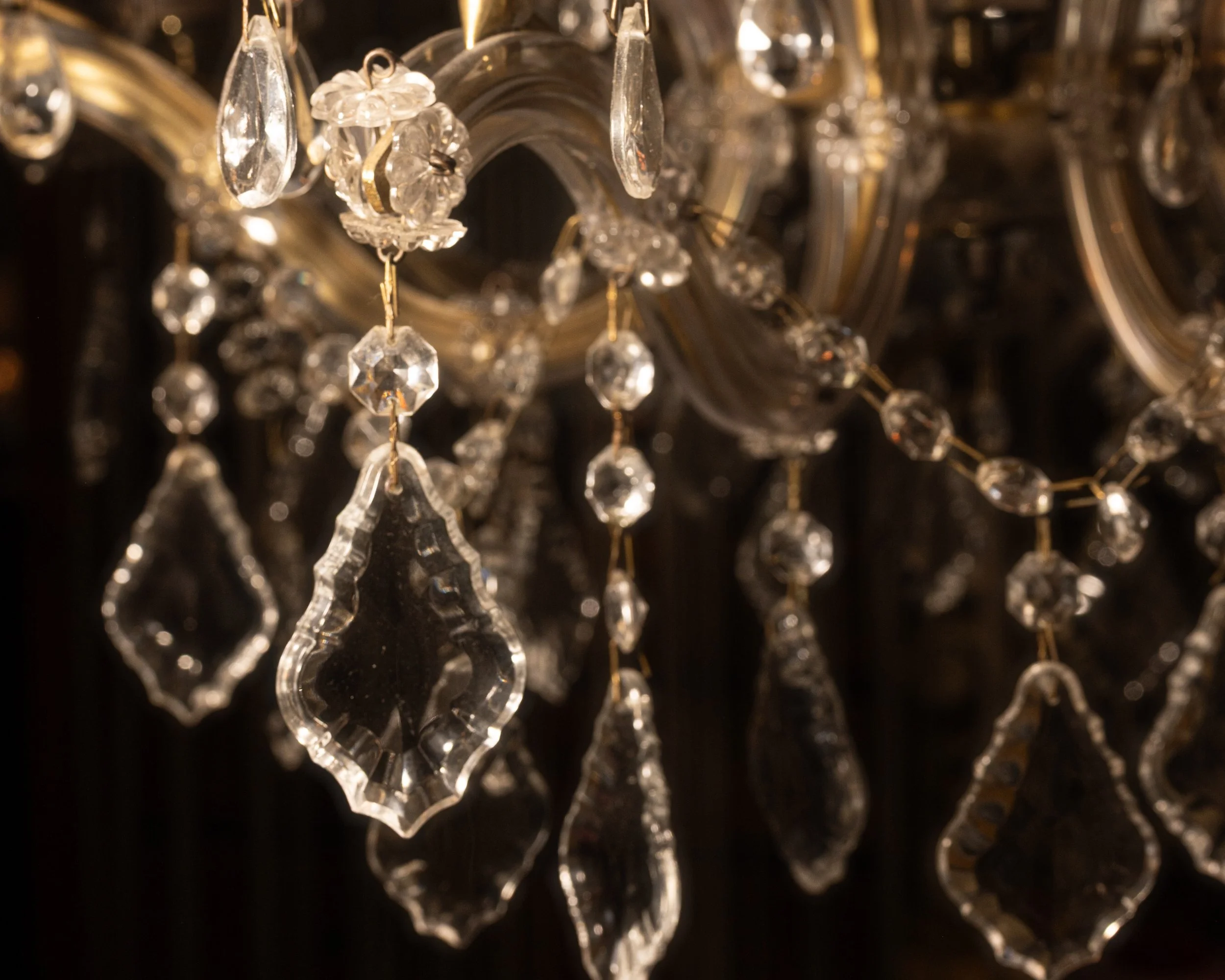 Close-up of a chandelier with crystal ornaments hanging from it.