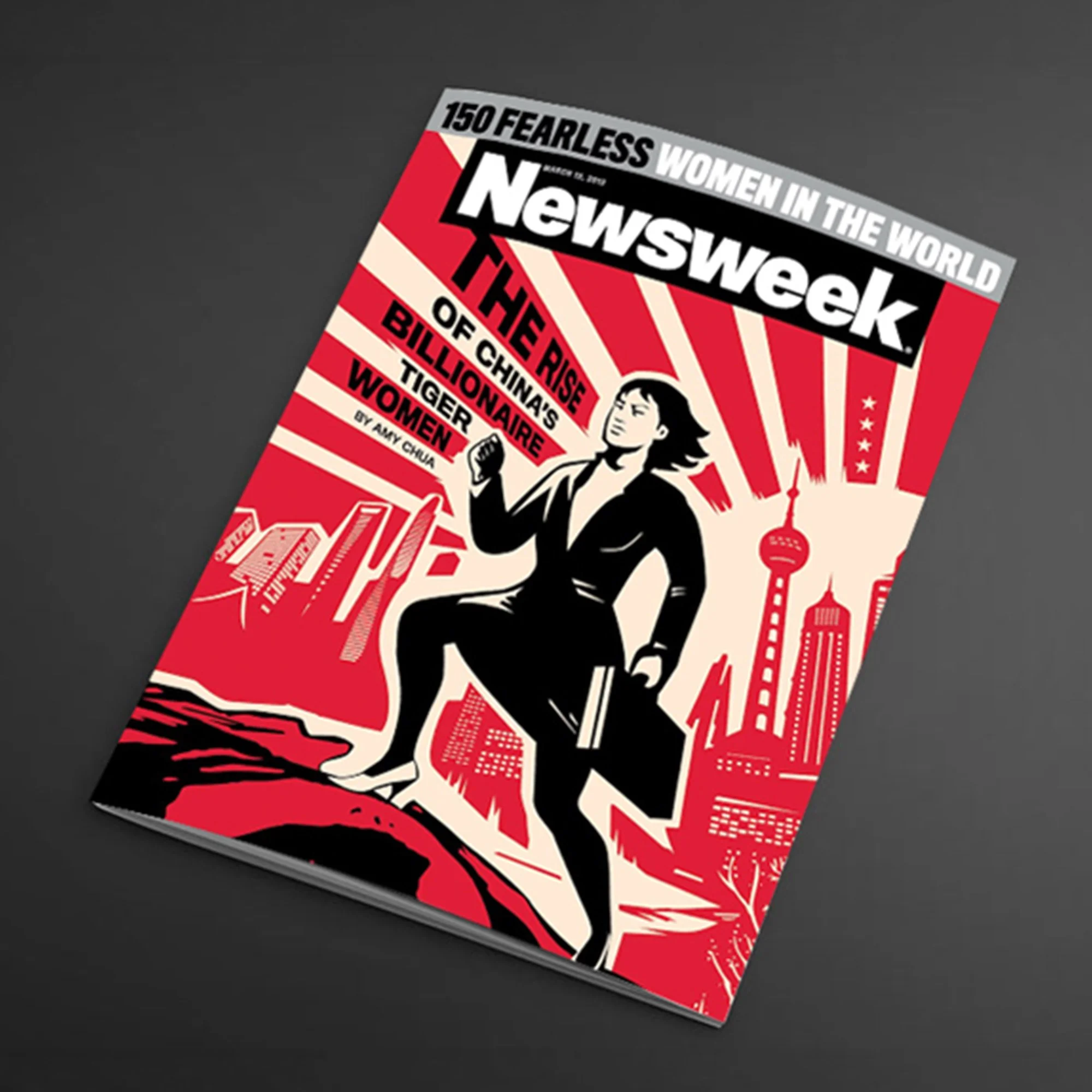A magazine cover titled '150 Fearless Women in the World' with a black-and-white illustration of a woman in a victory pose, surrounded by red and white graphic elements of city skylines and buildings.