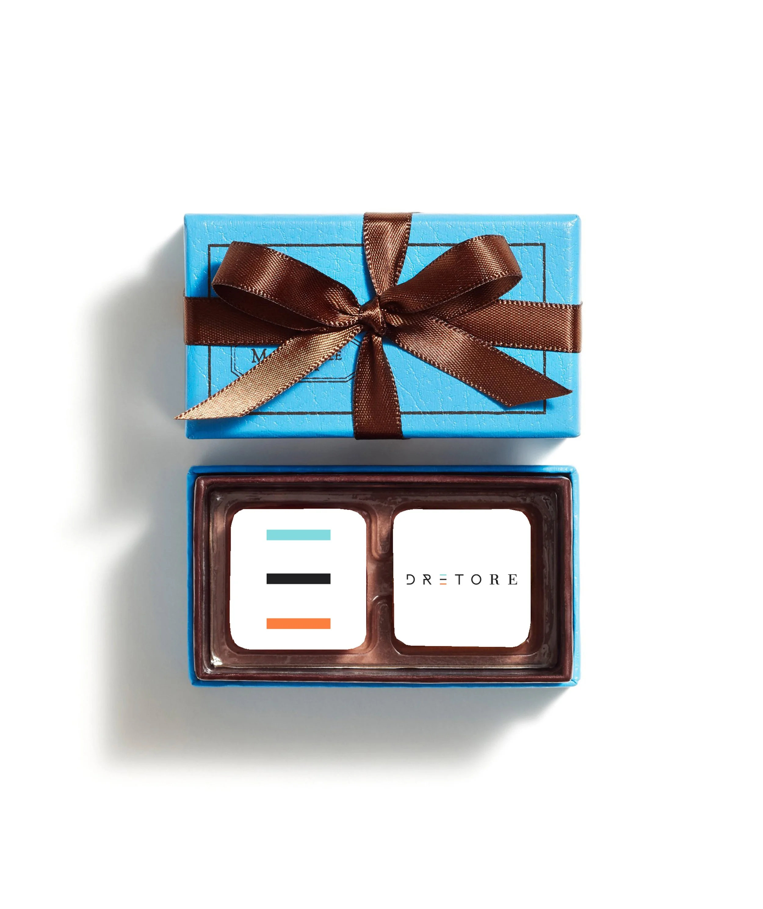 A blue gift box with a brown satin ribbon tied in a bow, placed on a white surface.