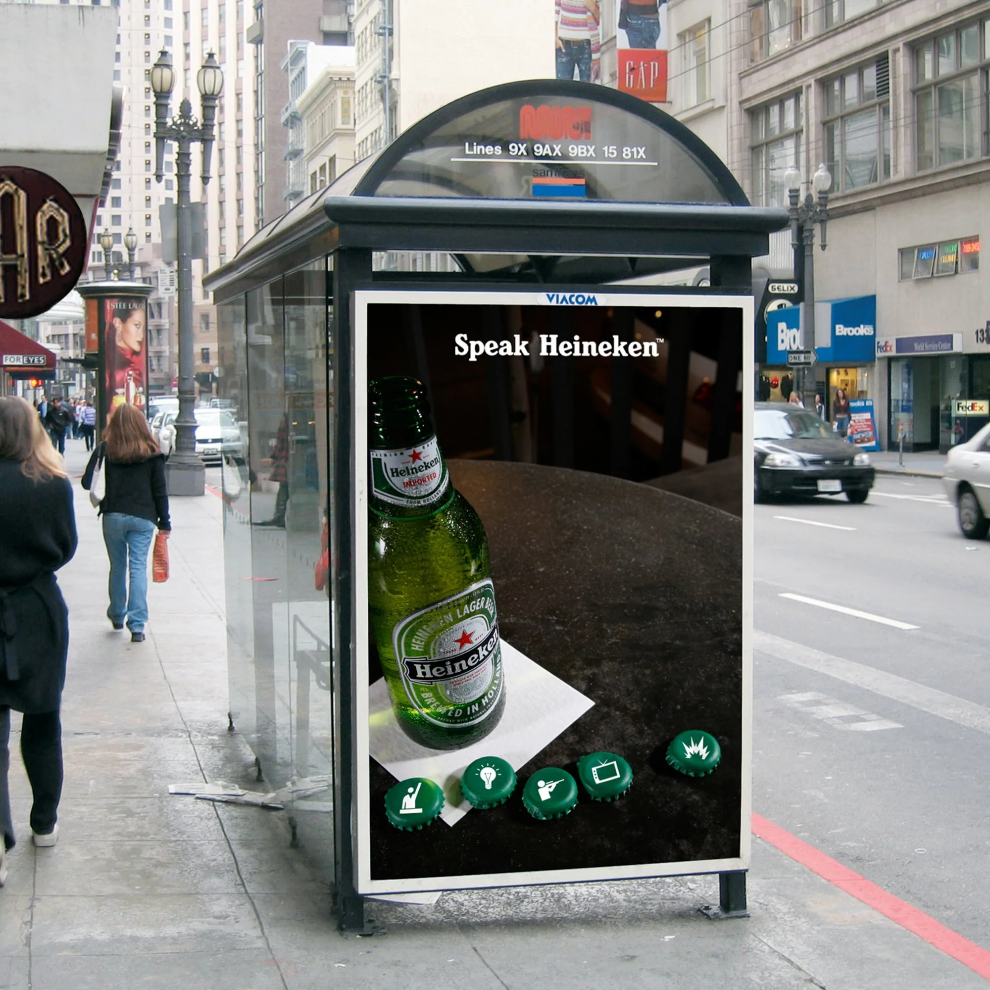City street scene with people walking, tall buildings, a bus stop shelter, and an advertisement with a Heineken beer bottle on the display.