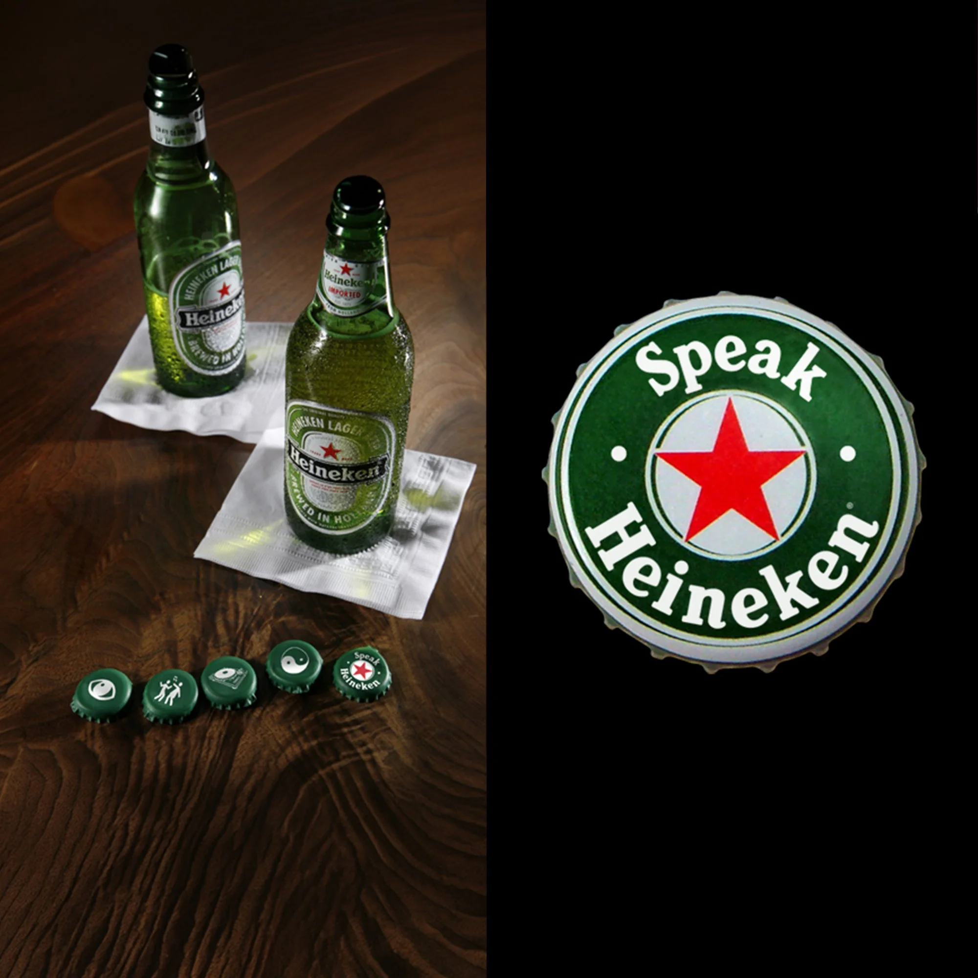 Two bottles of Heineken beer on a white napkin on a wooden table, with some bottle caps and icons at the bottom, and part of a circular sign reading 'speak Heineken'.
