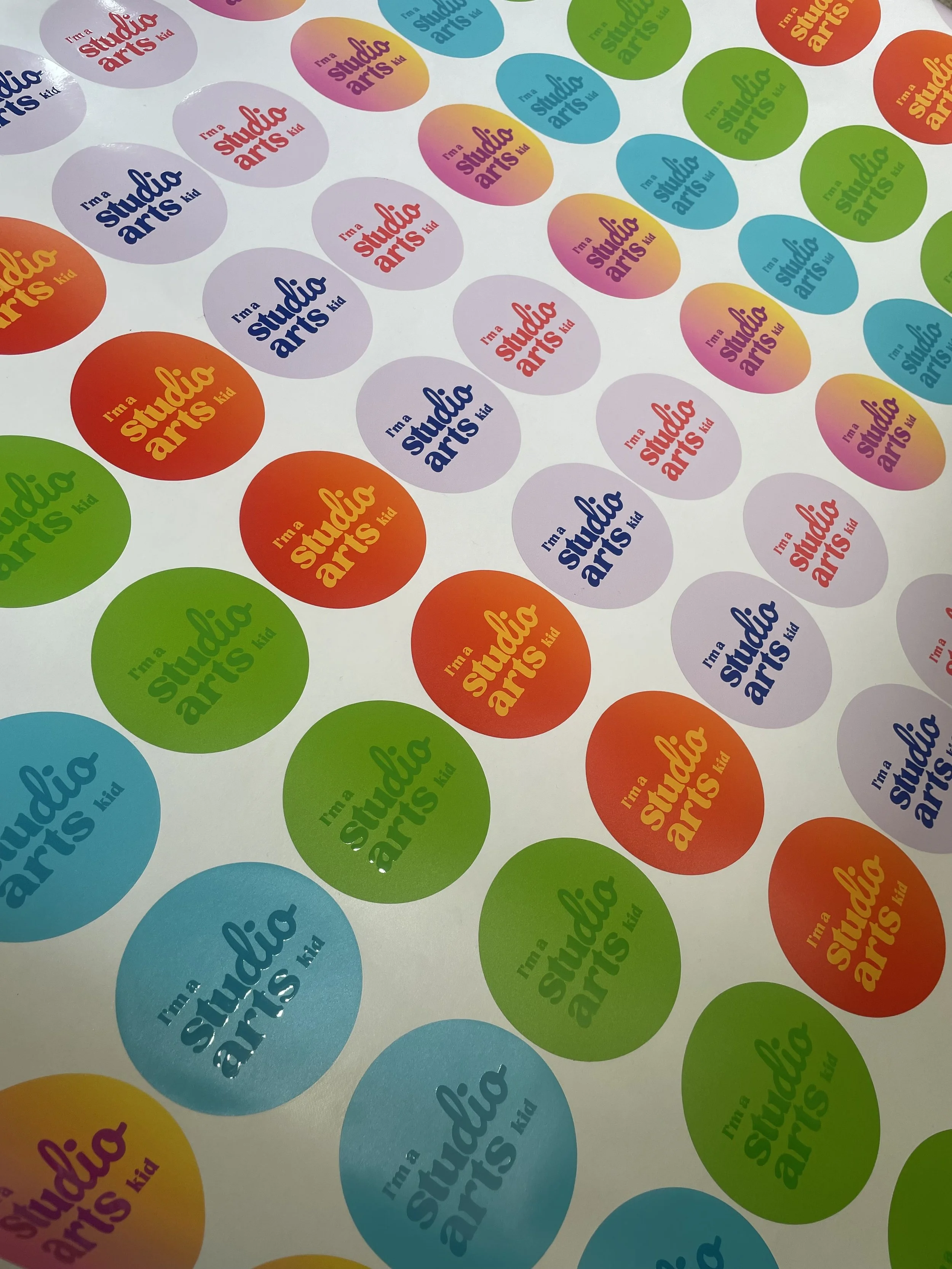 Colorful stickers with the phrase "I'm a studio arts kid" in various colors and fonts, arranged on a white surface.
