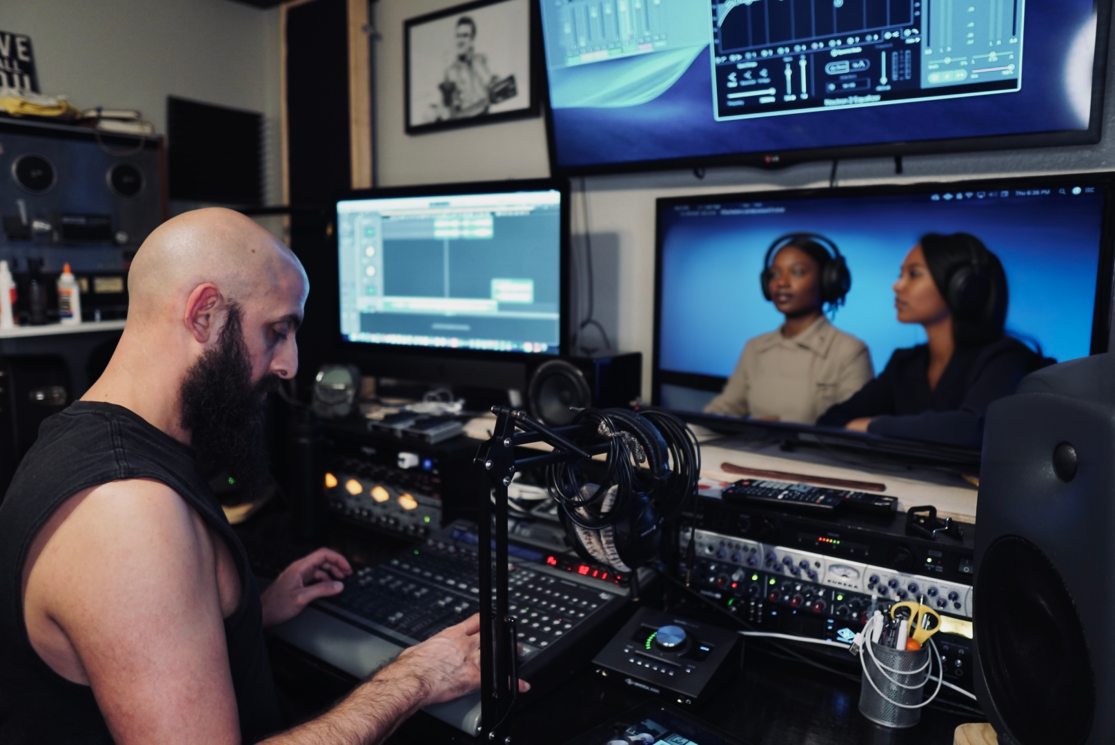 Konstantin Alexander mixing audio for a podcast session in a recording studio