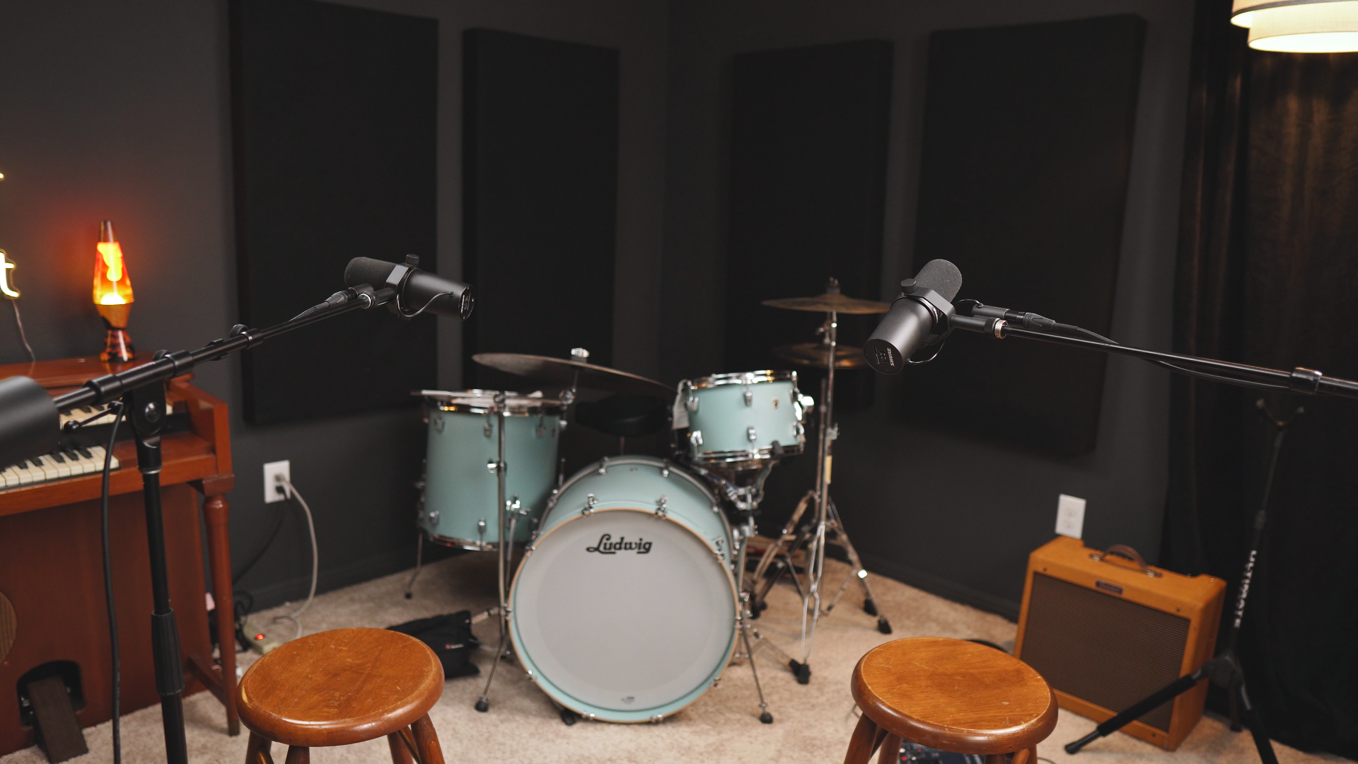 Podcast and music recording studio with microphones and acoustic-treated space