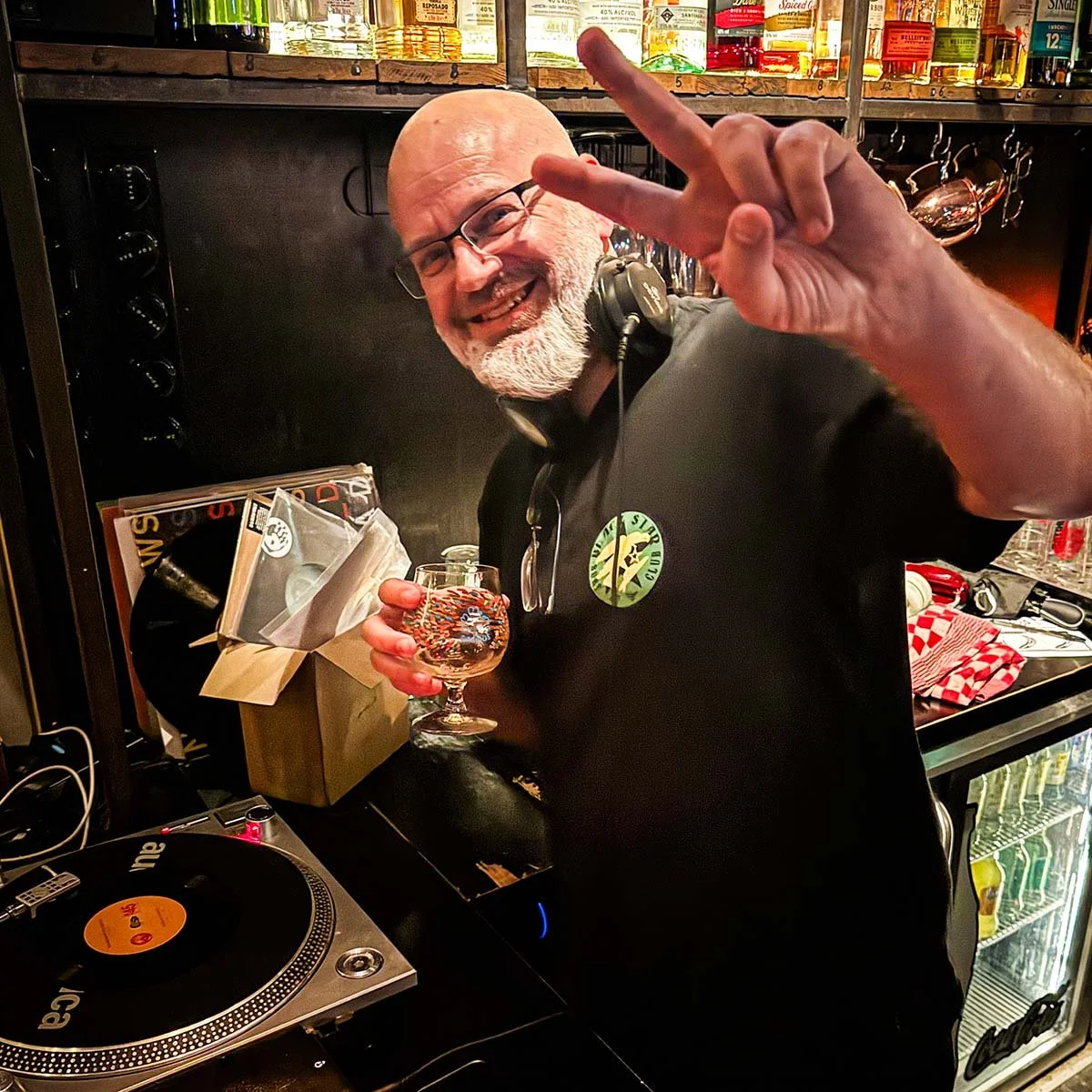 DJ Fresh Fruit at the turntables playing a guest DJ set at Amsterdam Vinyl Club, a live music community event.