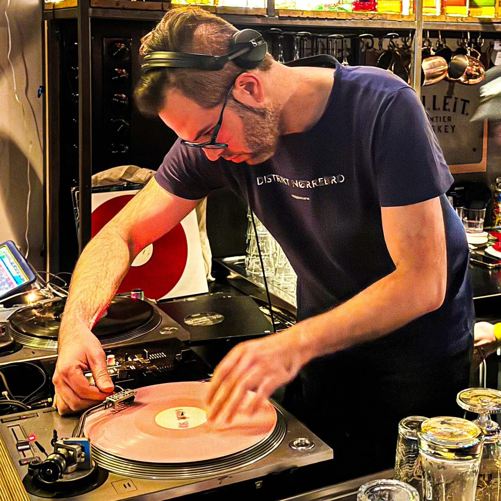 DJ Ermac at the turntables playing a guest DJ set at Amsterdam Vinyl Club, a live music community event.
