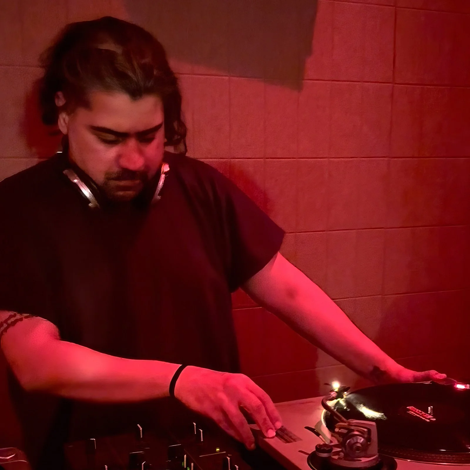Deepak Nichani at the turntables playing a guest DJ set at Amsterdam Vinyl Club, a live music community event.