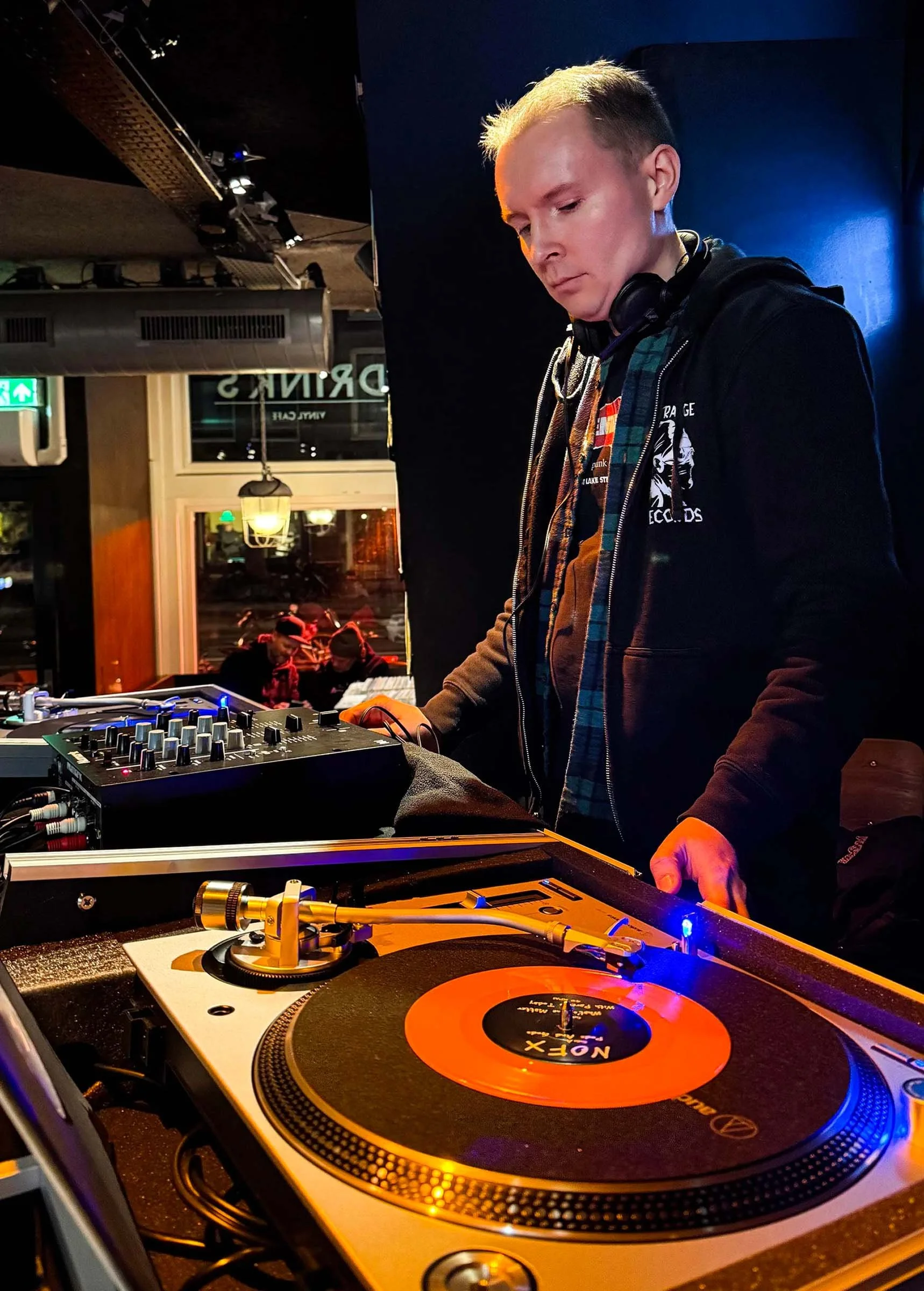 DJ Cherry Cola at the turntables playing a guest DJ set at Amsterdam Vinyl Club, a live music community event.