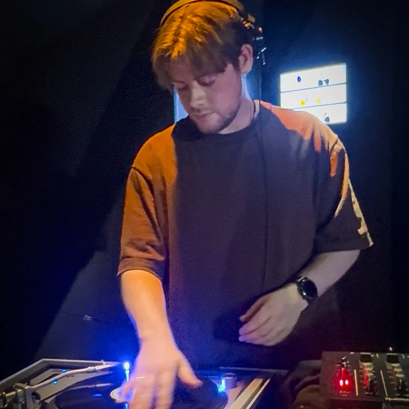 Mark McDermott at the turntables playing a guest DJ set at Amsterdam Vinyl Club, a live music community event.