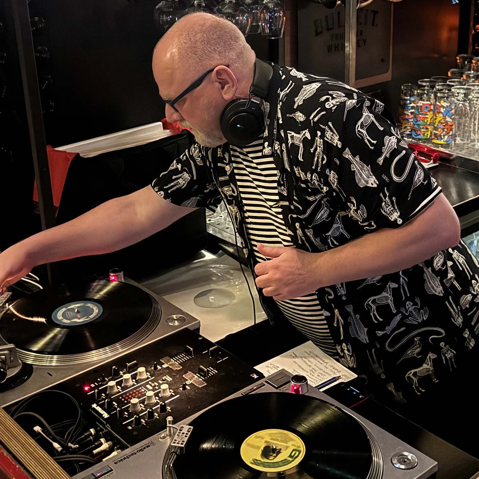 DJ Roland at the turntables playing a guest DJ set at Amsterdam Vinyl Club, a live music community event.