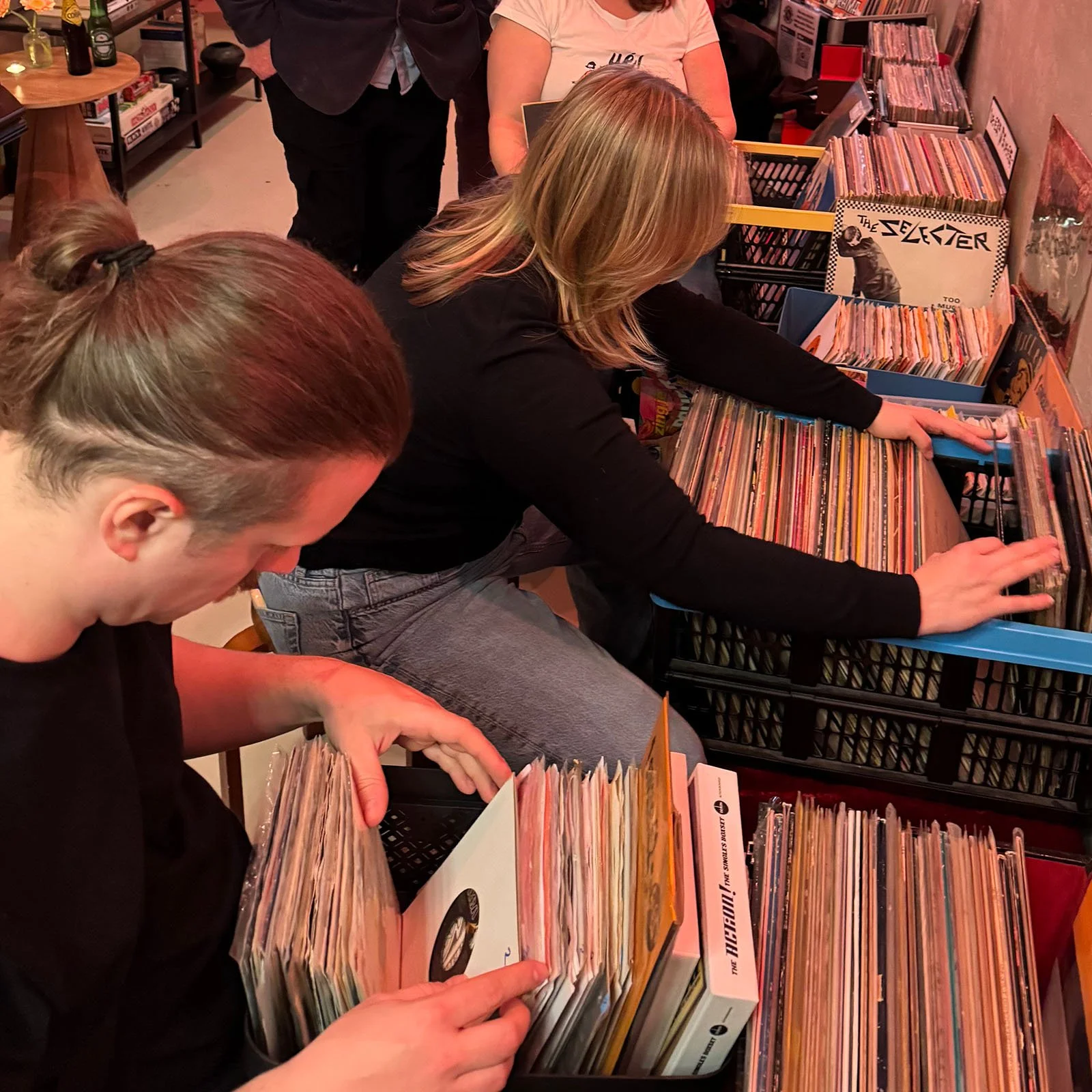 People browsing through vinyl records at an Amsterdam Vinyl Club live event.