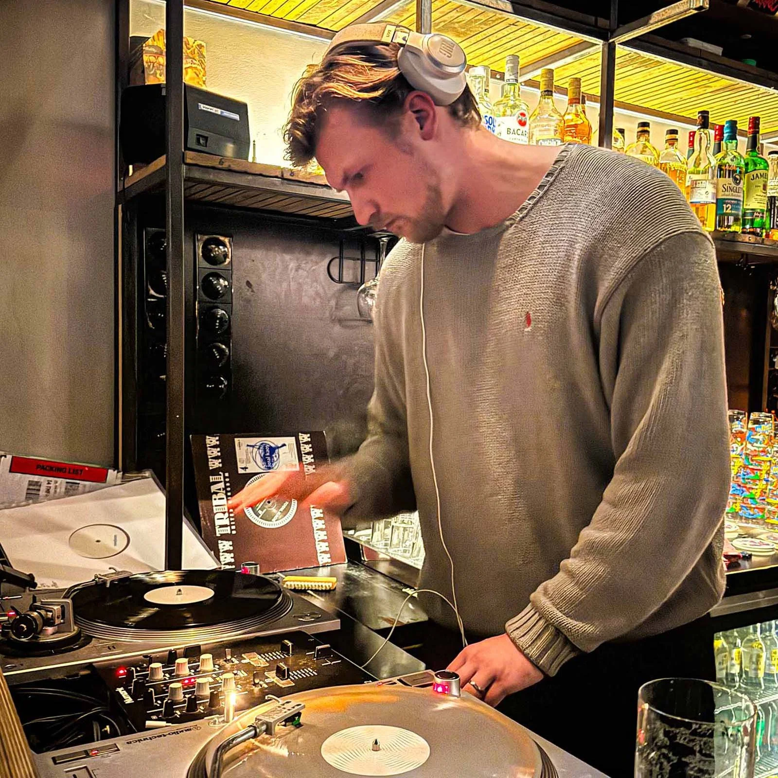 farmer (Juri) at the turntables playing a guest DJ set at Amsterdam Vinyl Club, a live music community event.