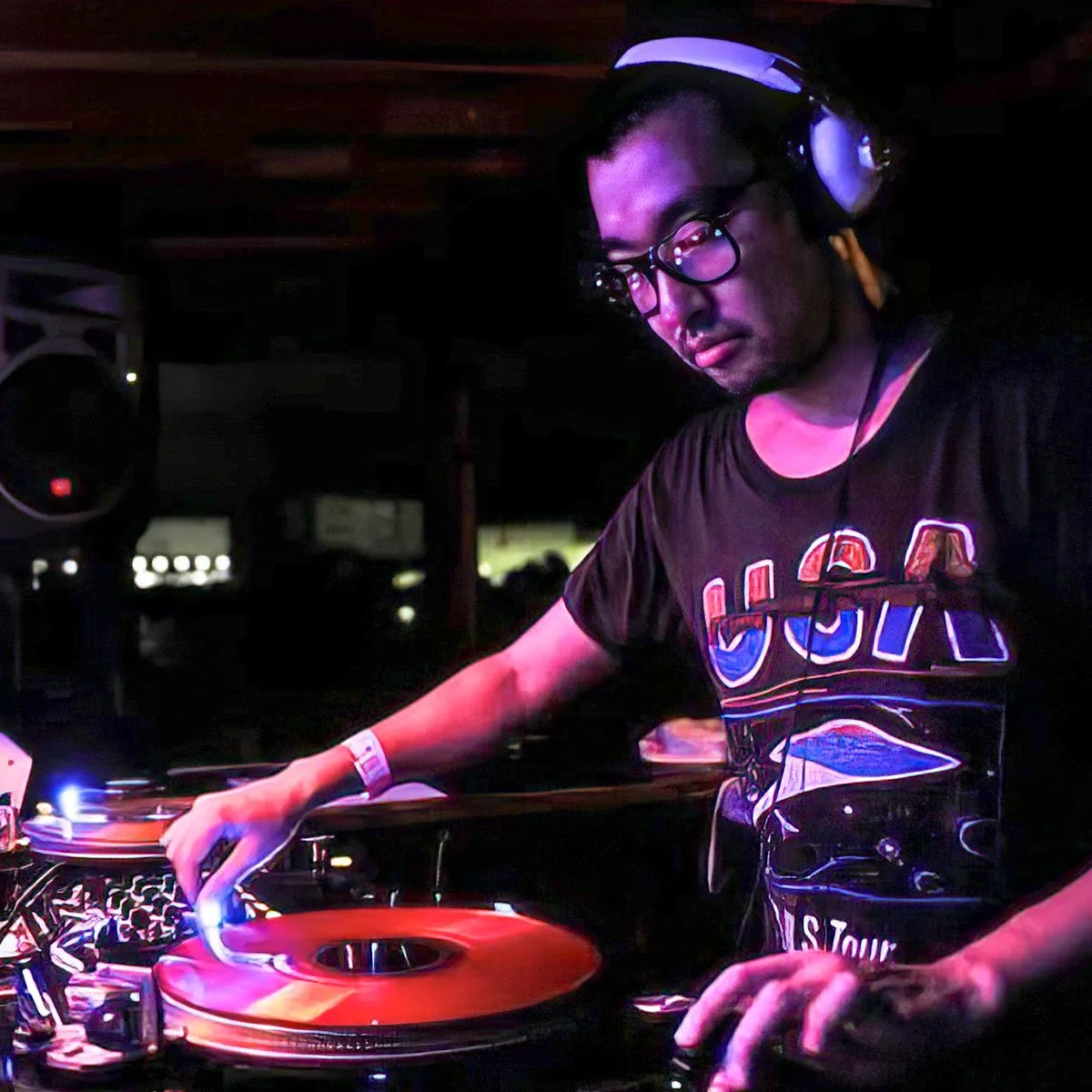 DJ Hatchobori at the turntables playing a guest DJ set at Amsterdam Vinyl Club, a live music community event.