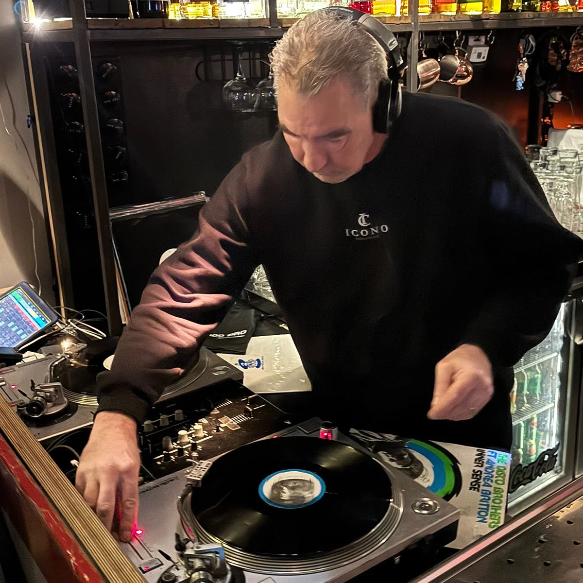 DJ Jaimy at the turntables playing a guest DJ set at Amsterdam Vinyl Club, a live music community event.