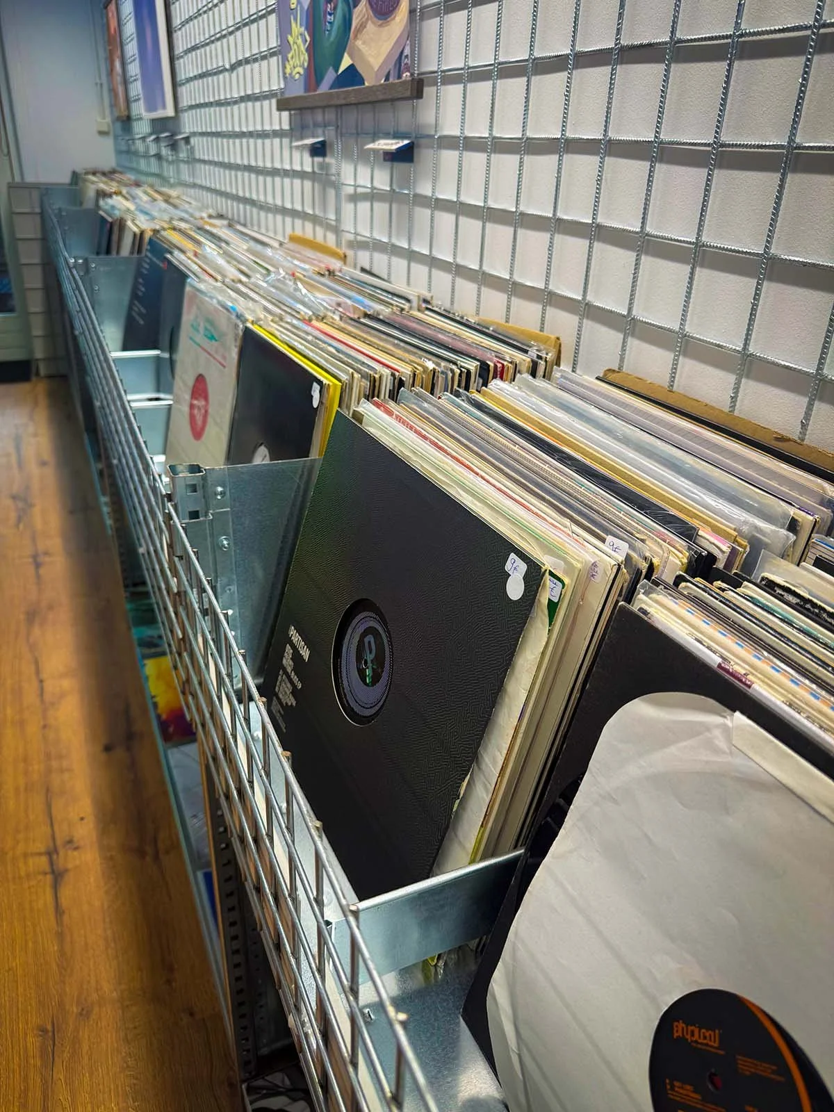 The interior of GOT.DRIP Streetwear and Records, a vinyl and clothing store in Amsterdam, Netherlands. There are hundreds of vinyl records on display.