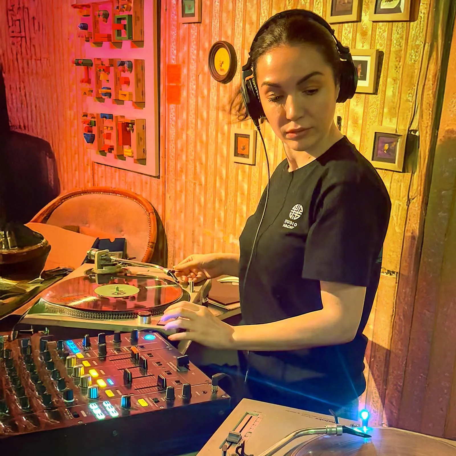Sophia Sigma at the turntables playing a guest DJ set at Amsterdam Vinyl Club, a live music community event.